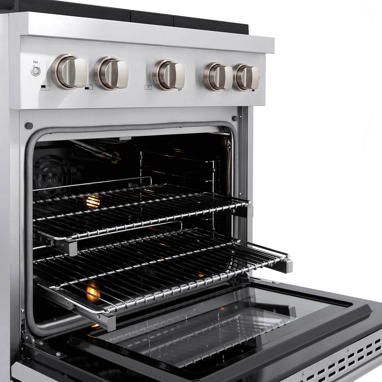 Stainless gas range oven interior with racks and glowing burner igniter points visible