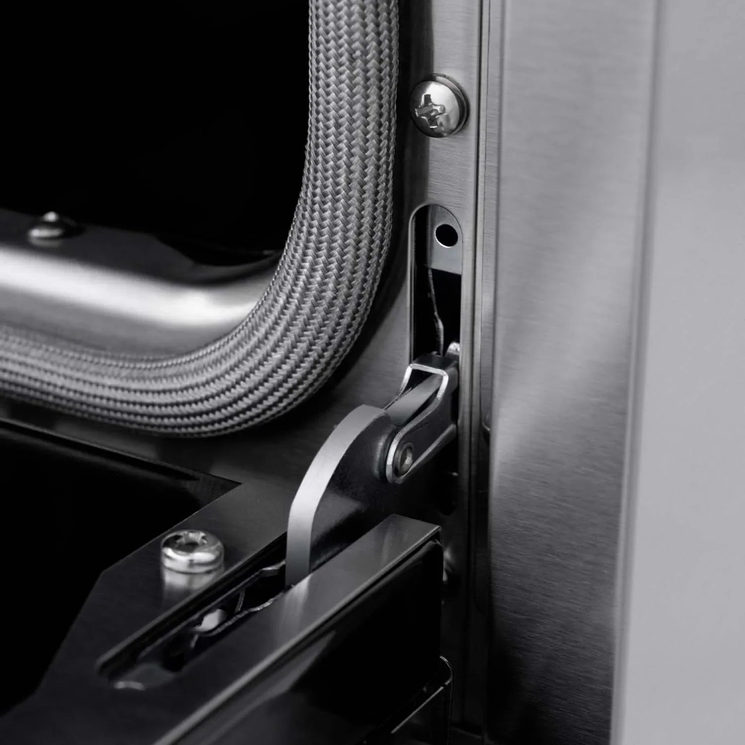 Stainless steel gas range side detail with braided gas line and mounting bracket