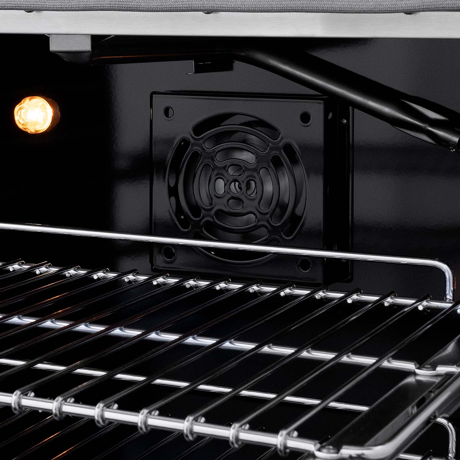 Gas oven interior with wire racks and visible rear burner cover