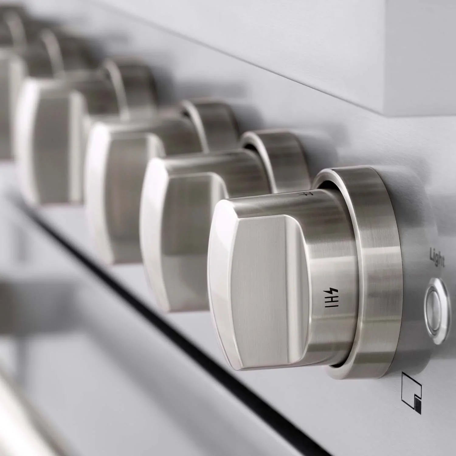 Stainless steel gas range control knobs with burner labels, side view