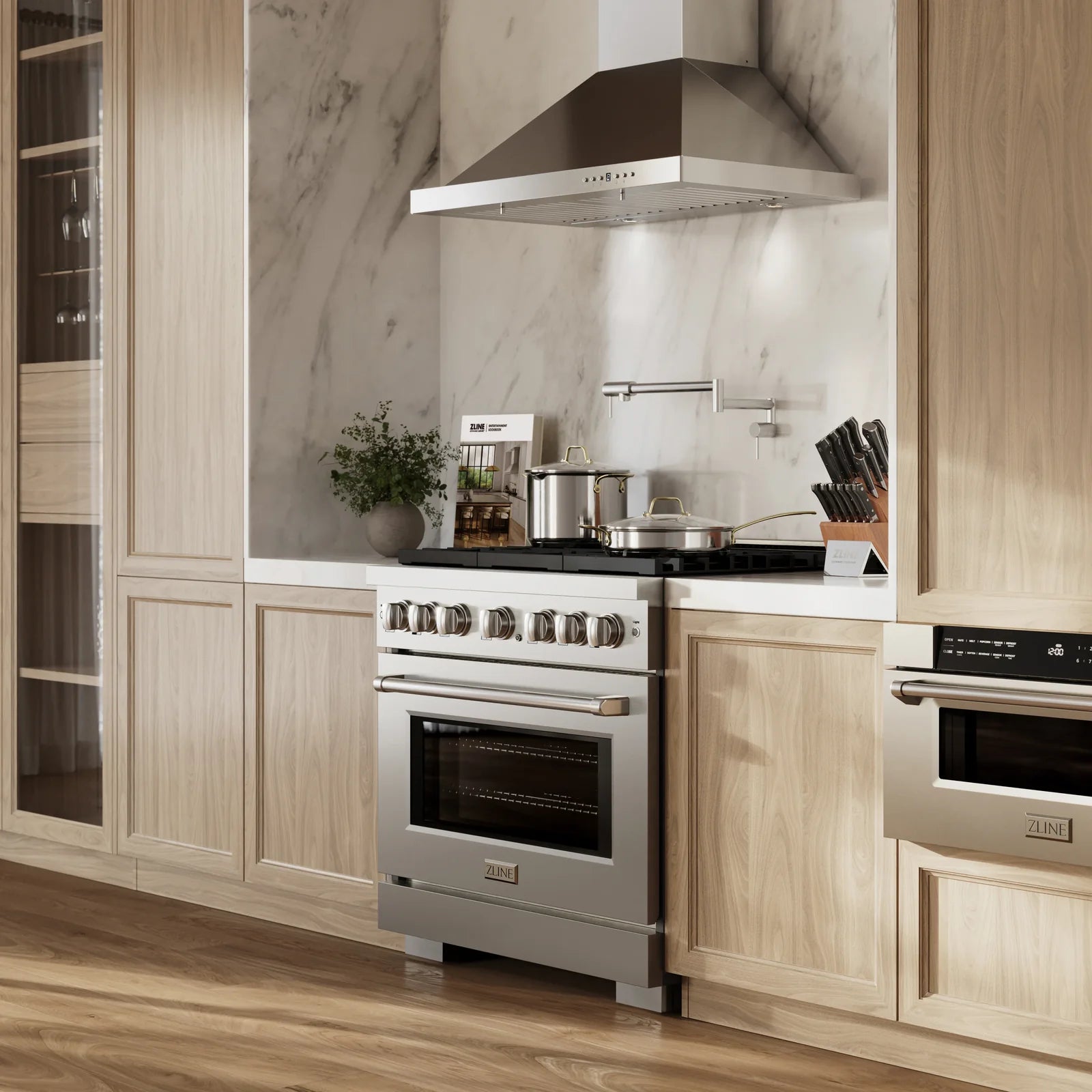 Stainless steel gas range and wall hood installed in a modern kitchen