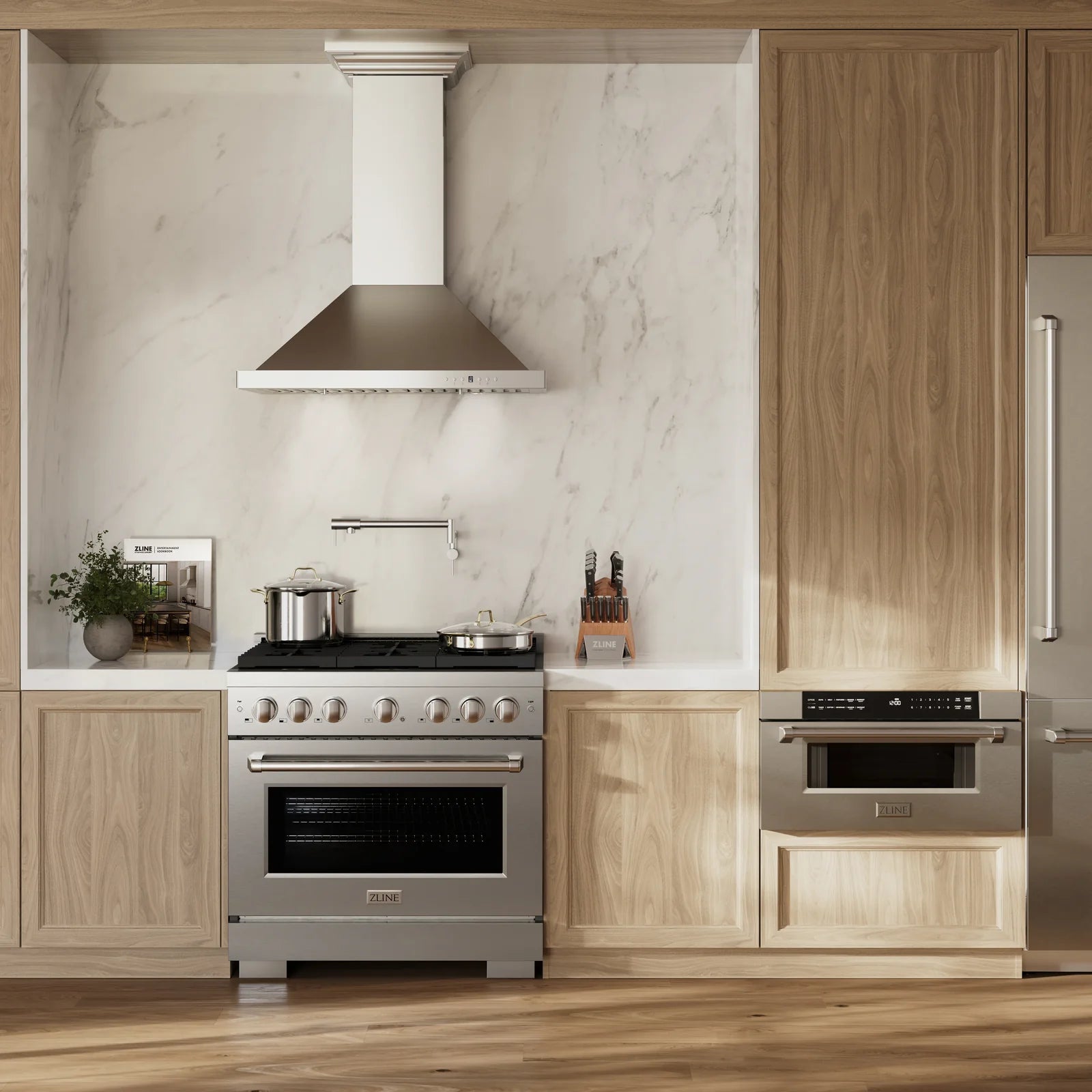 Stainless gas range and chimney-style hood between light wood cabinets in kitchen