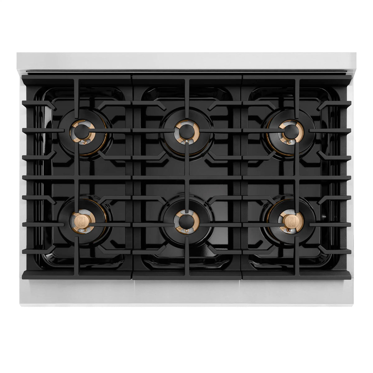 Six-burner gas cooktop with black cast grates and brass-colored burner caps