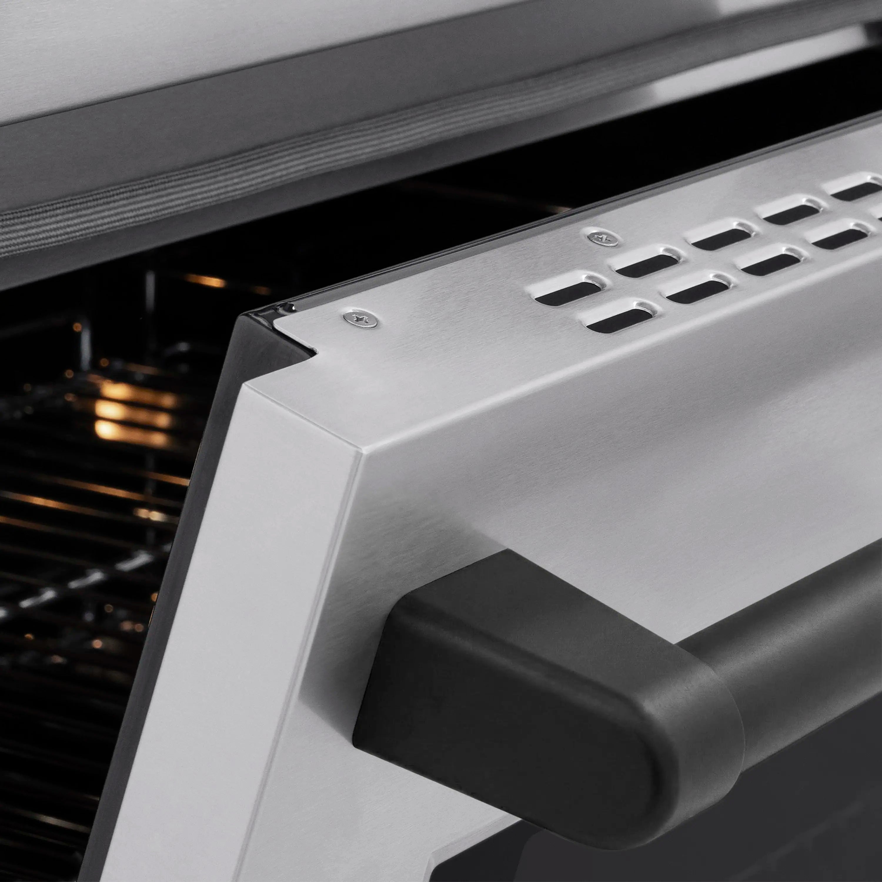 Matte black oven handle on stainless steel oven door frame