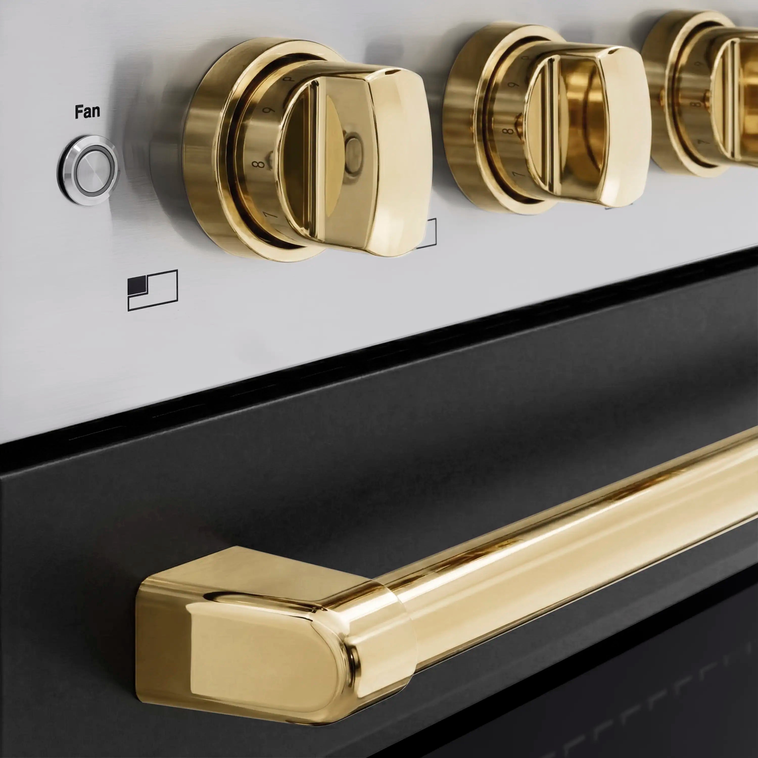 Gold oven and range control knobs on black cooktop panel, close-up