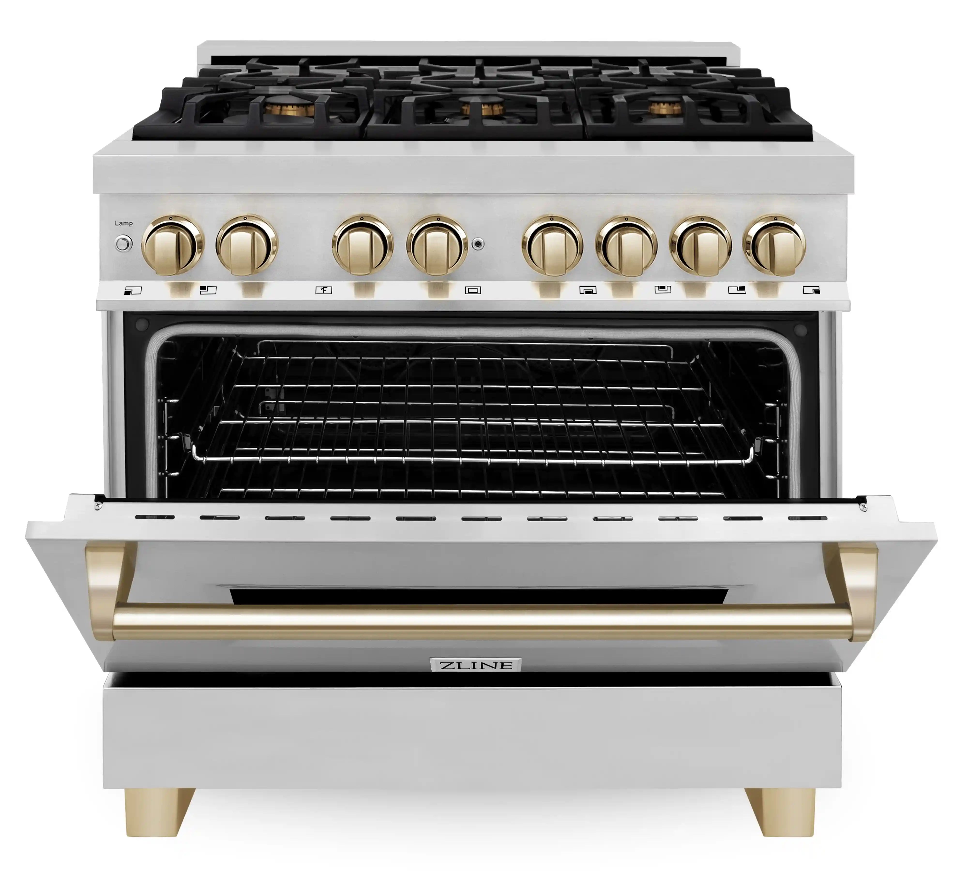 Stainless steel dual fuel range with open oven cavity and gold handle accents