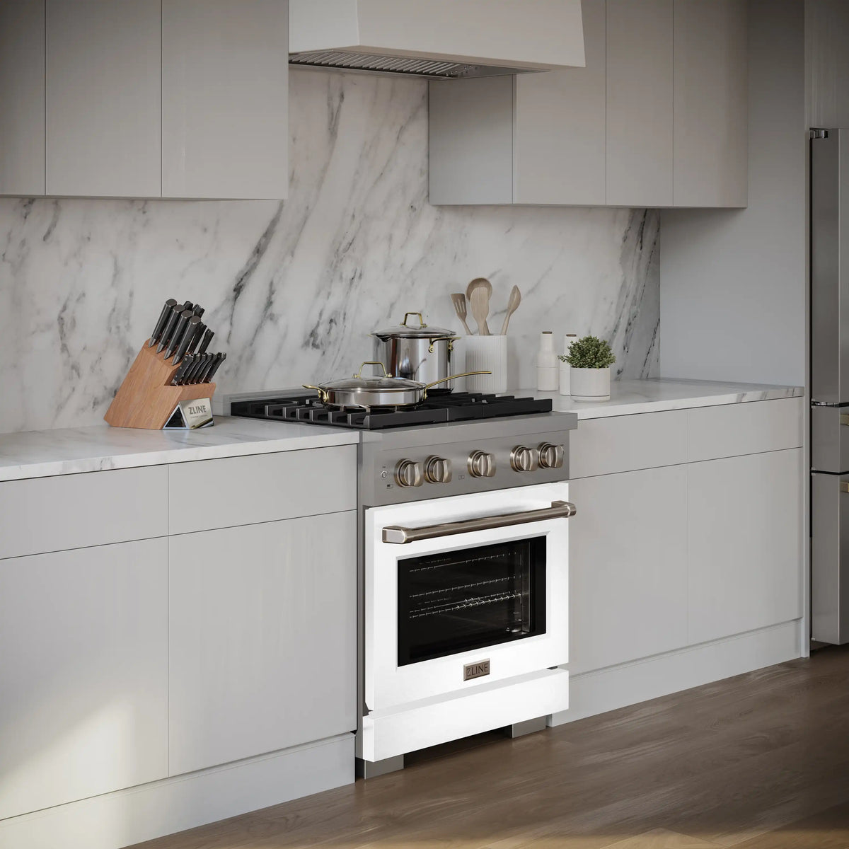 Stainless gas range with white matte oven door and four-burner cooktop