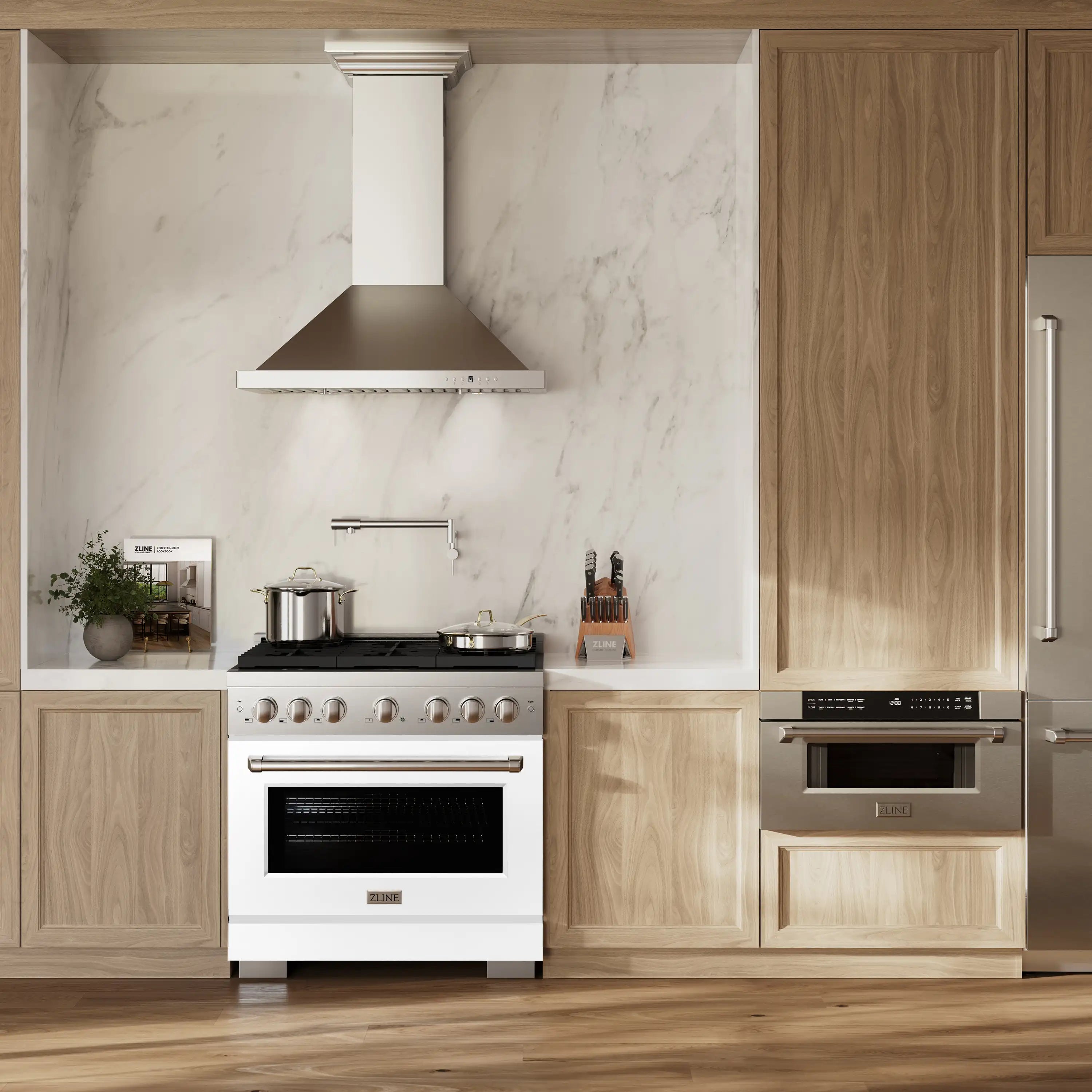 White gas range with stainless chimney hood installed in a kitchen