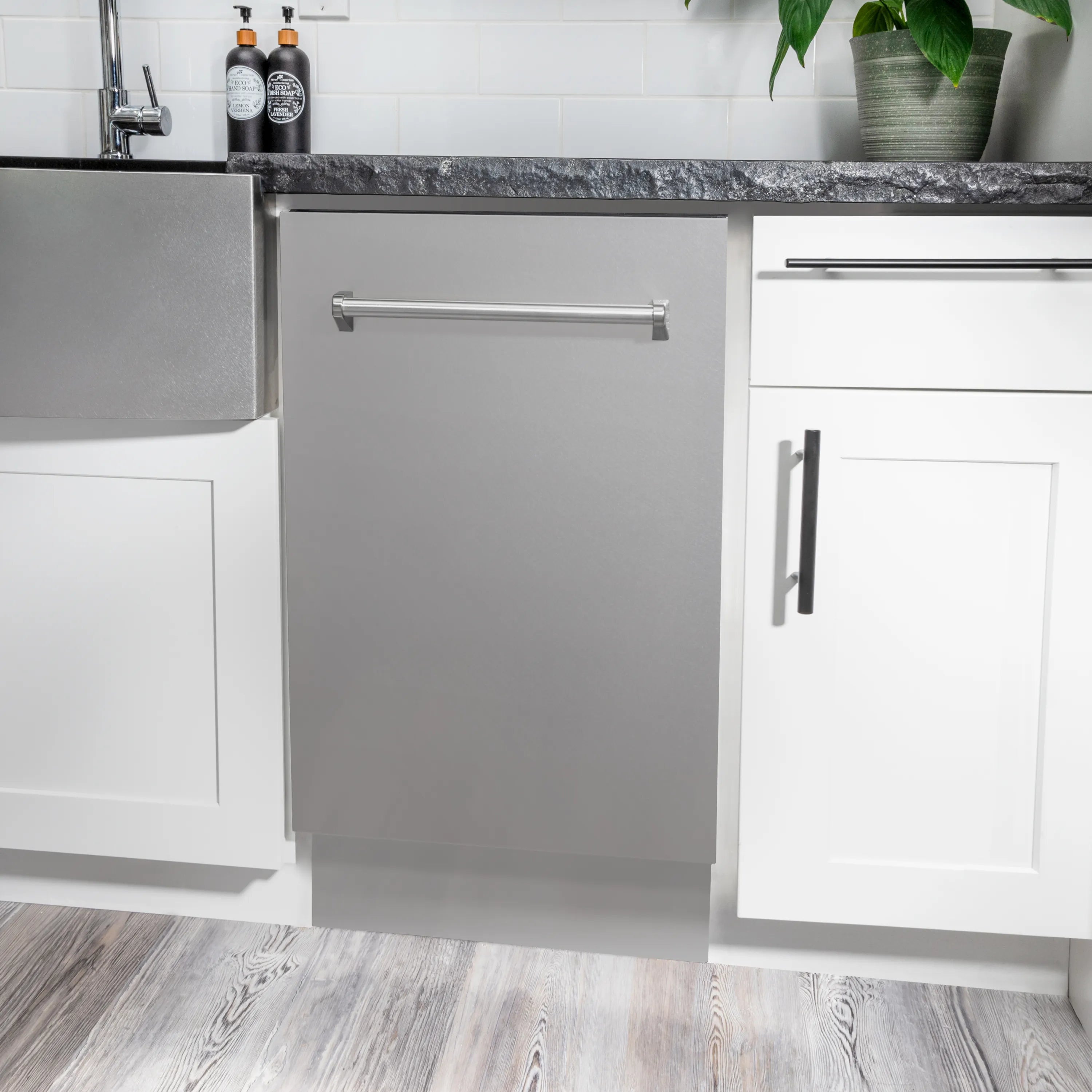 Built-in stainless steel dishwasher with front door open and top handle