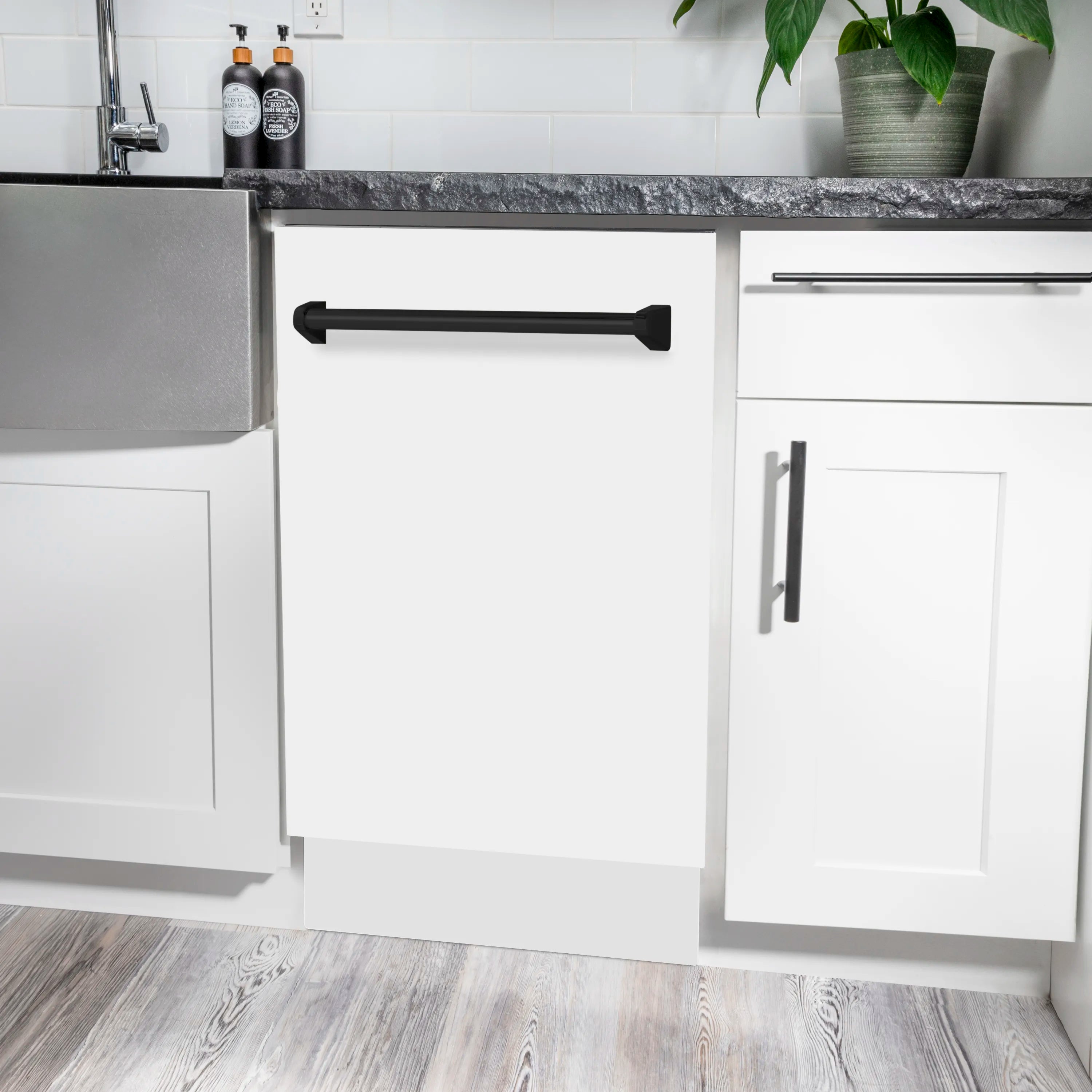 White matte dishwasher under-counter with matte black handle and open door
