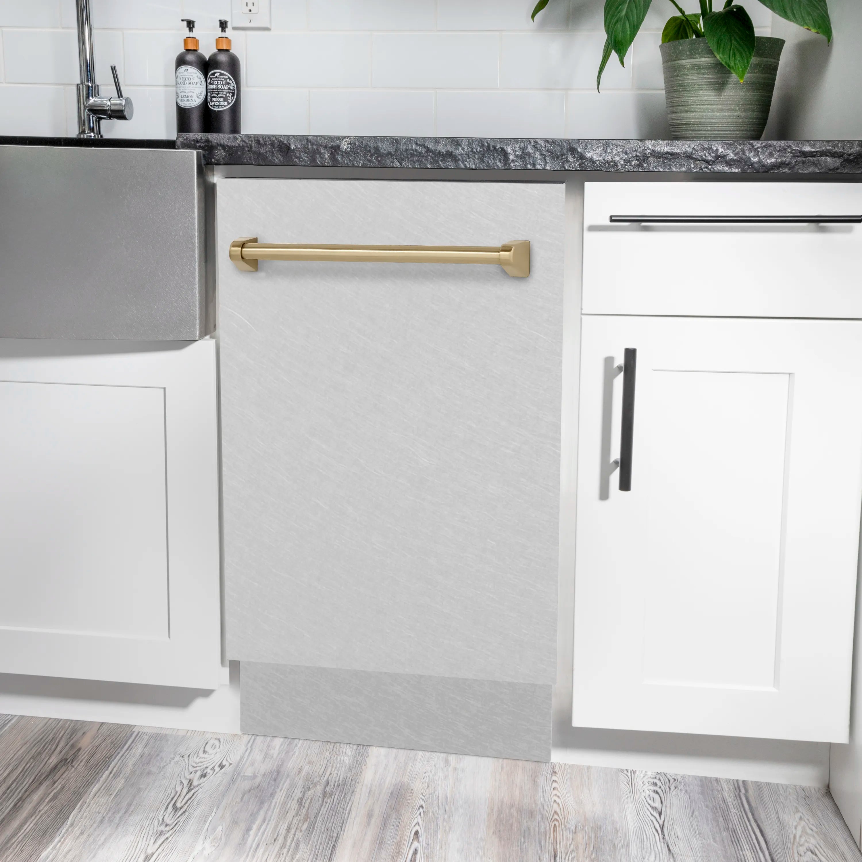 Compact dishwasher front with champagne bronze handle on satin stainless steel