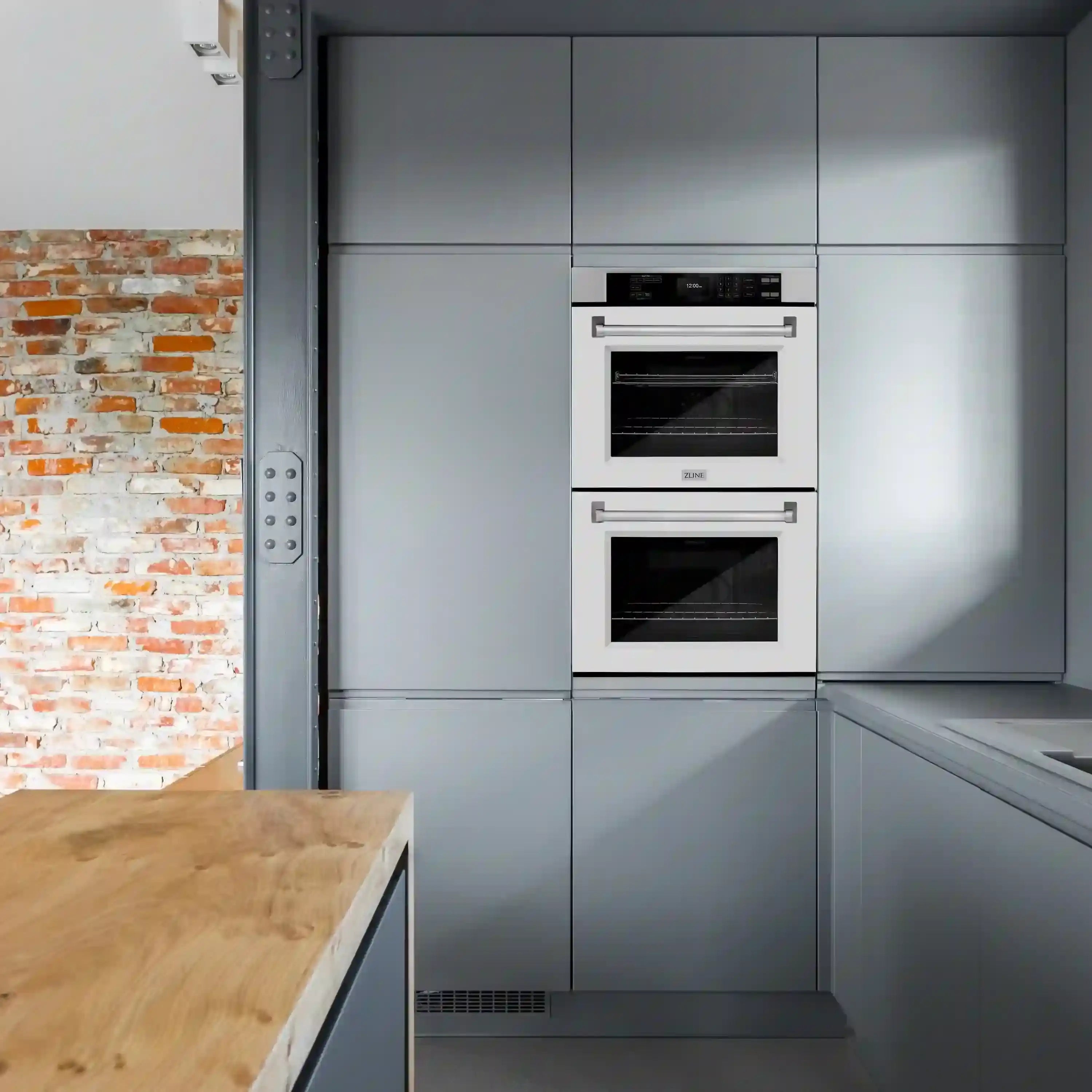 Built-in matte white double wall oven installed in a modern kitchen cabinet opening
