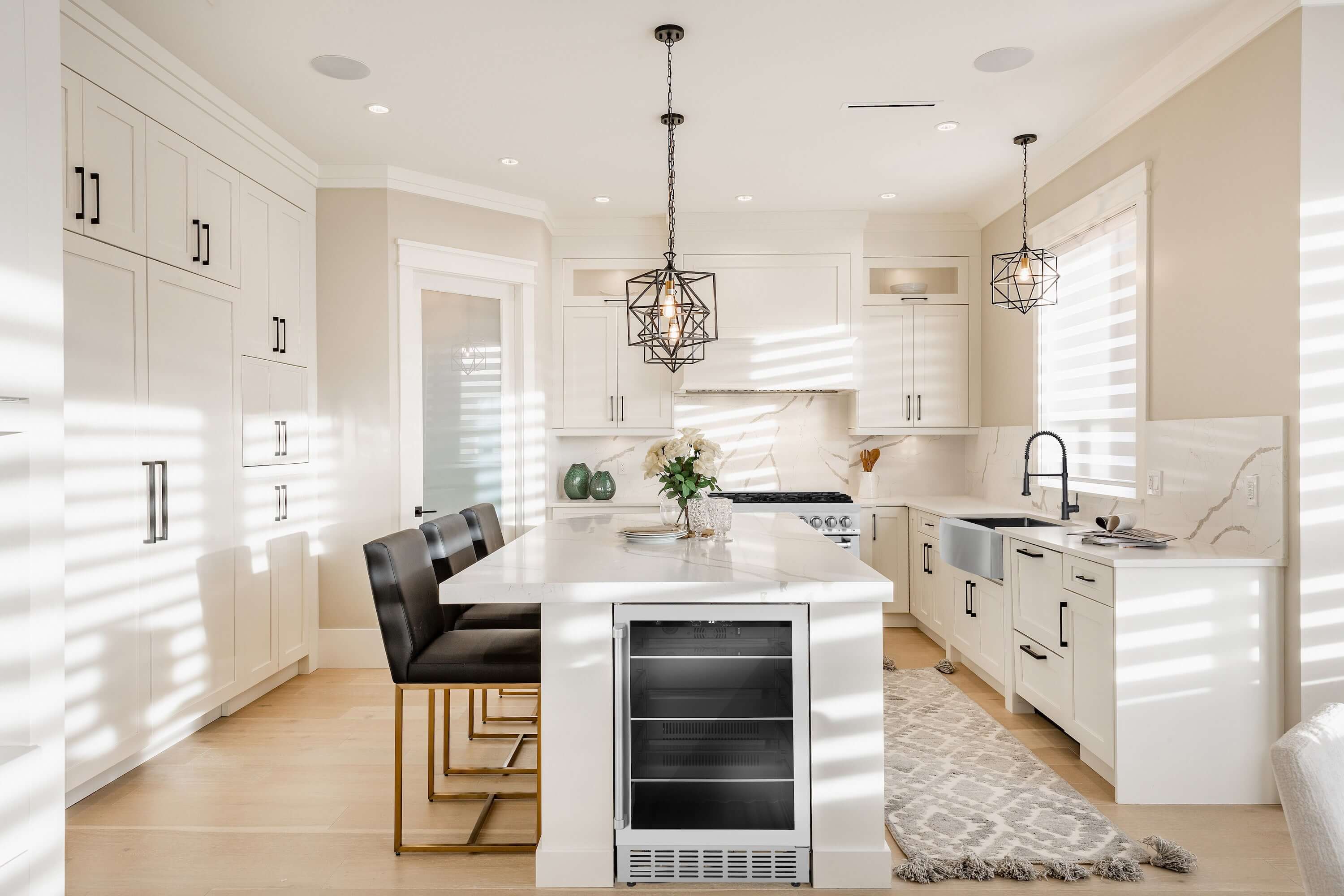 Stainless steel beverage fridge built into a kitchen island with drawers