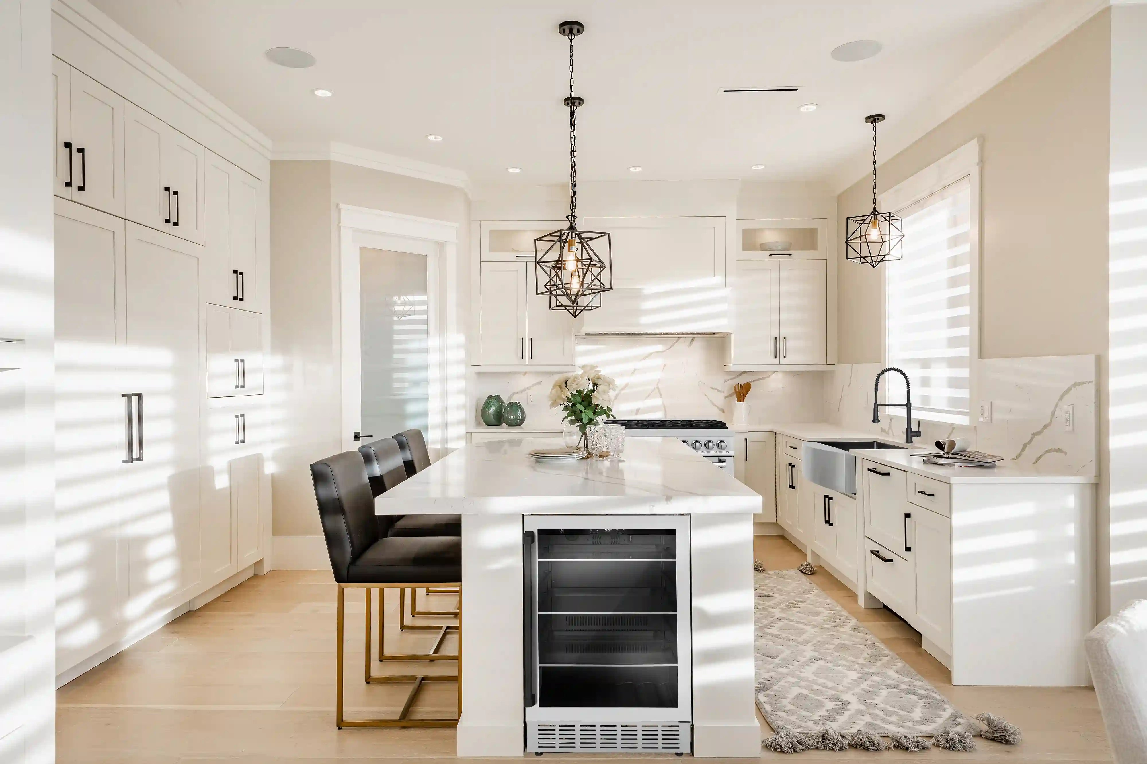 Built-in stainless beverage fridge with black door accents in a kitchen island
