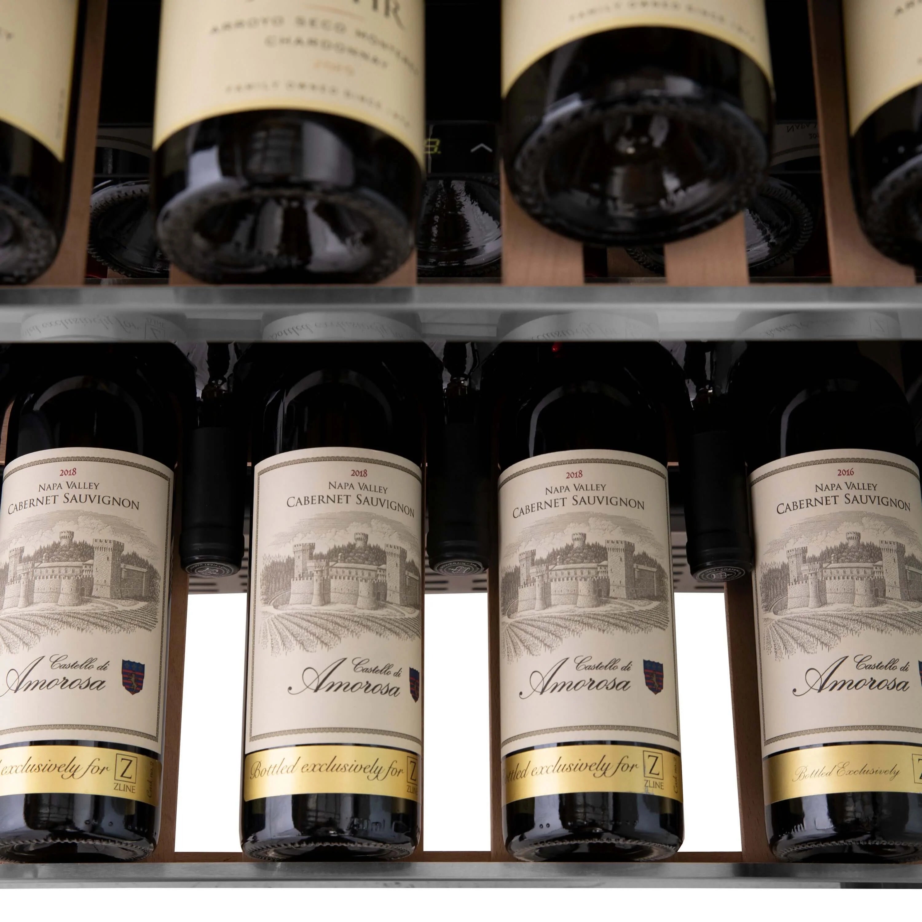 Wine cooler shelf with several bottles featuring cream labels and dark caps