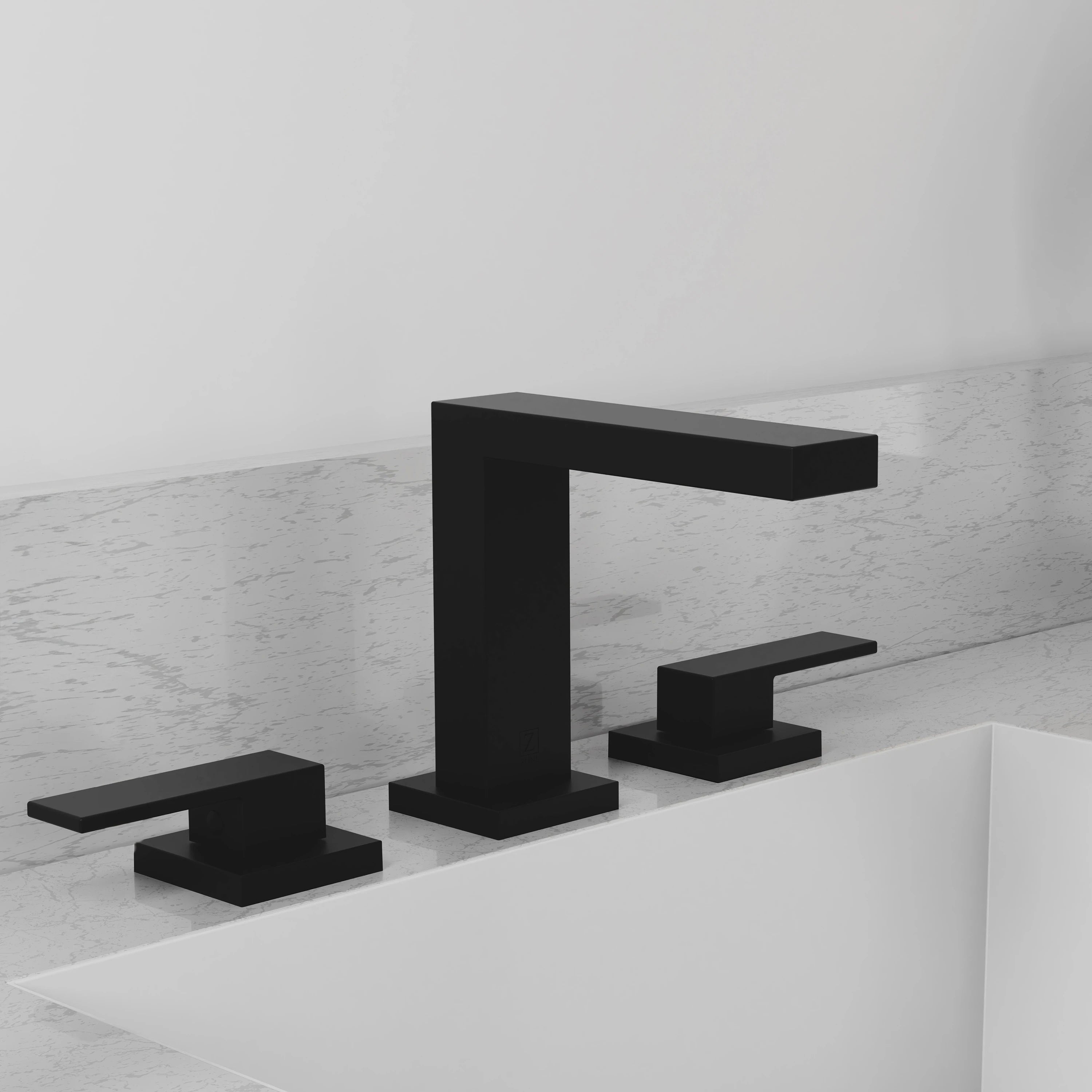 Matte black widespread bath faucet with tall spout and two deck handles over a tub