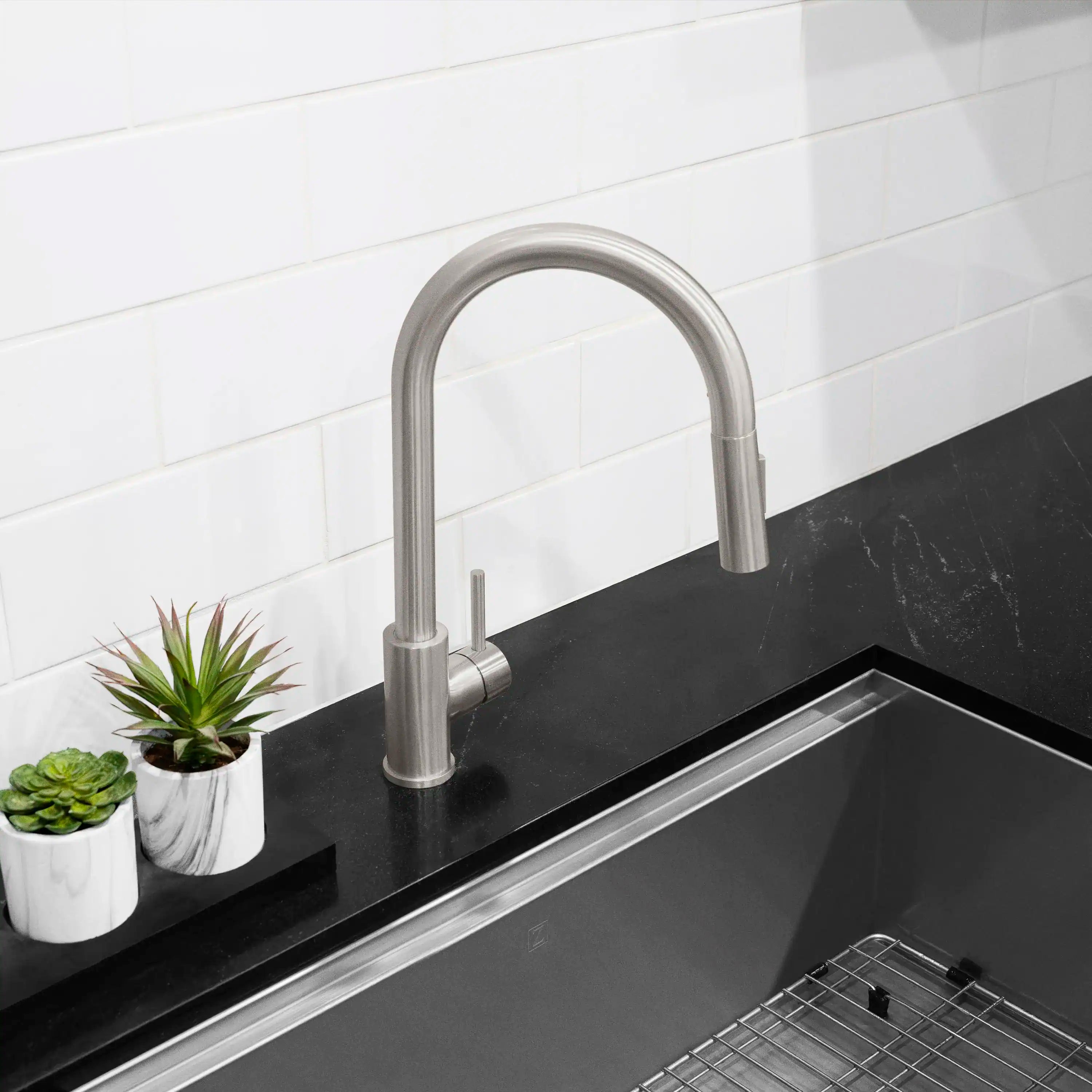 Brushed nickel pull-down kitchen faucet with single handle and arched spout