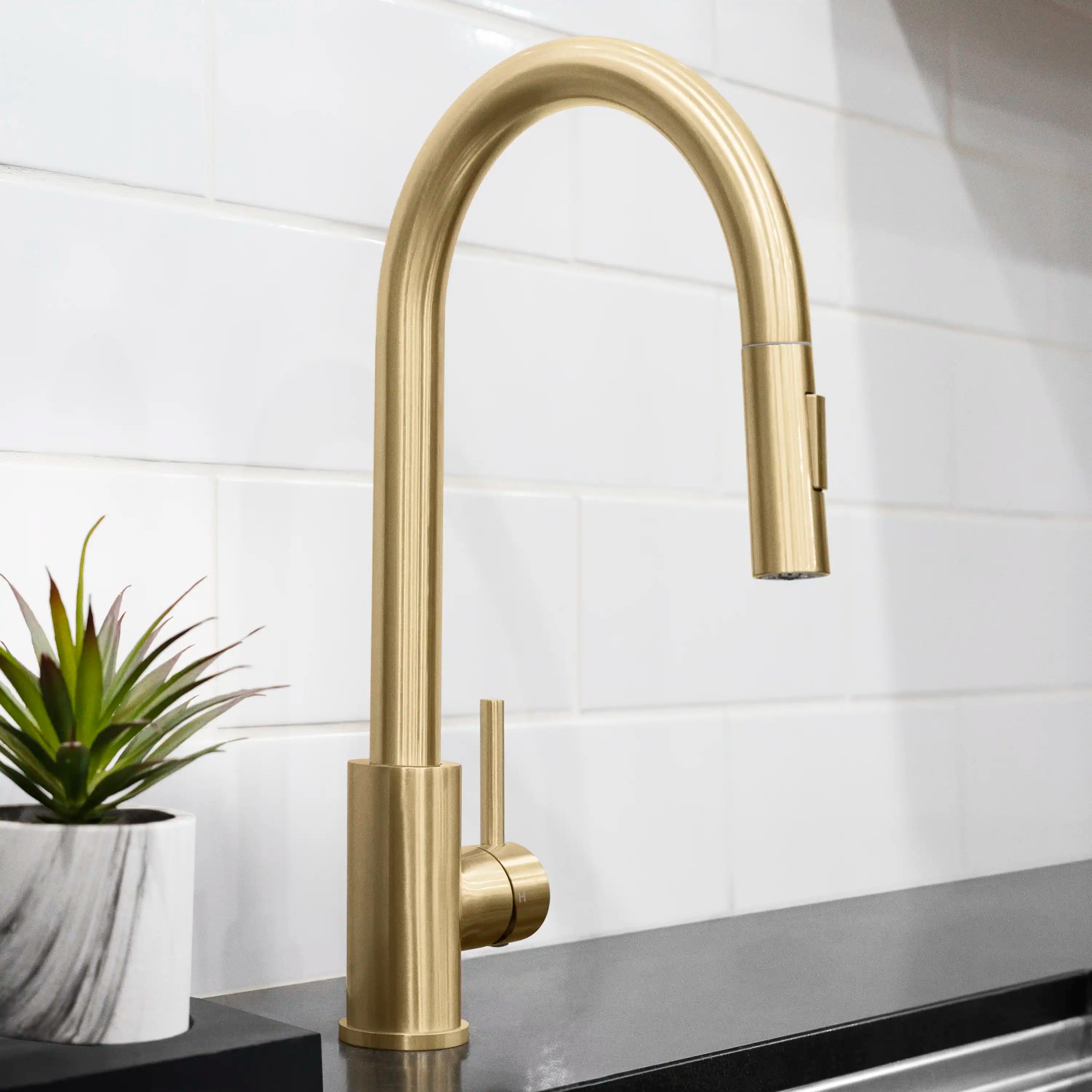 Champagne bronze single-handle kitchen faucet with arched spout and pull-down sprayer