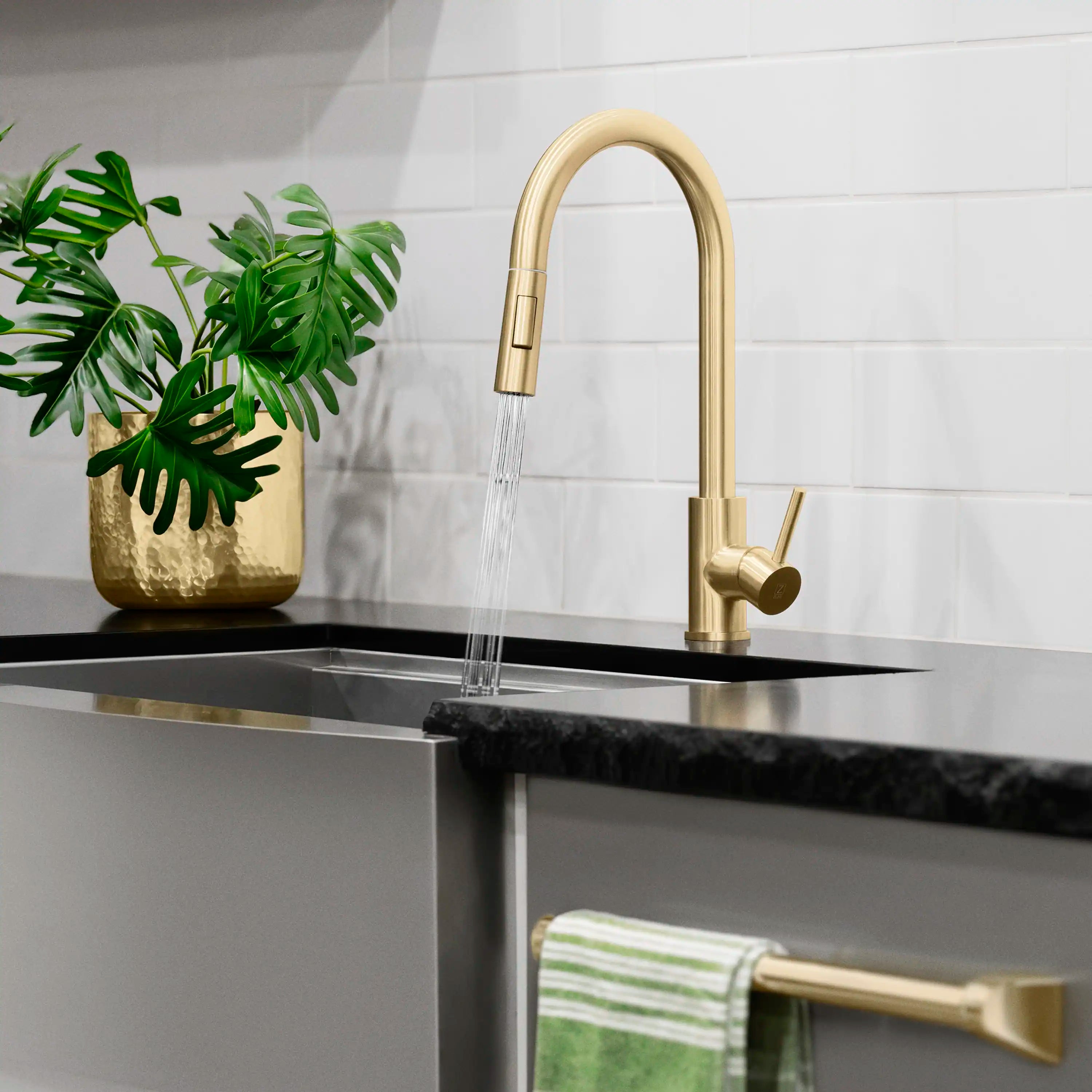 Champagne bronze kitchen faucet with arched spout and flowing water stream