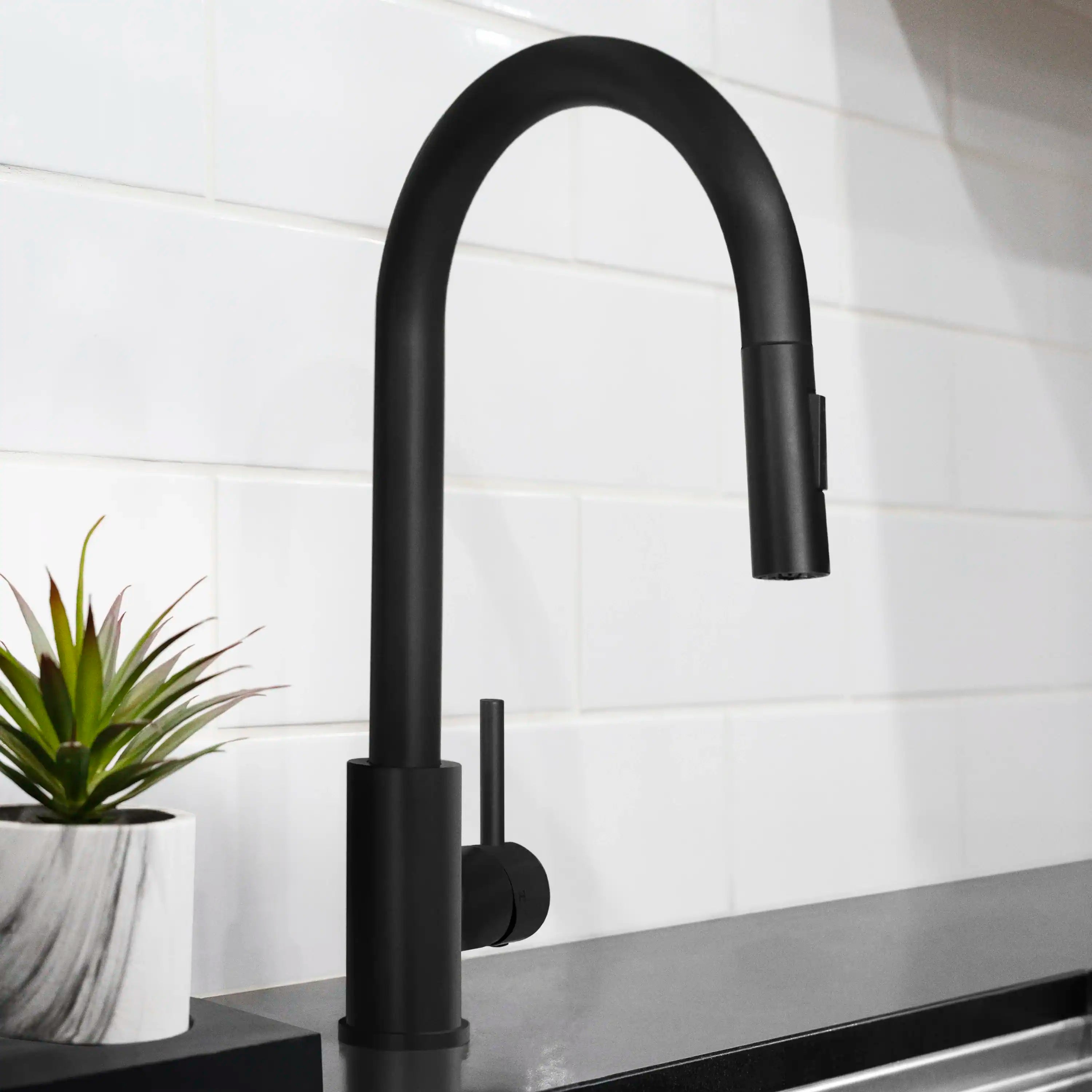Matte black pull-down kitchen faucet with tall curved spout and side control lever