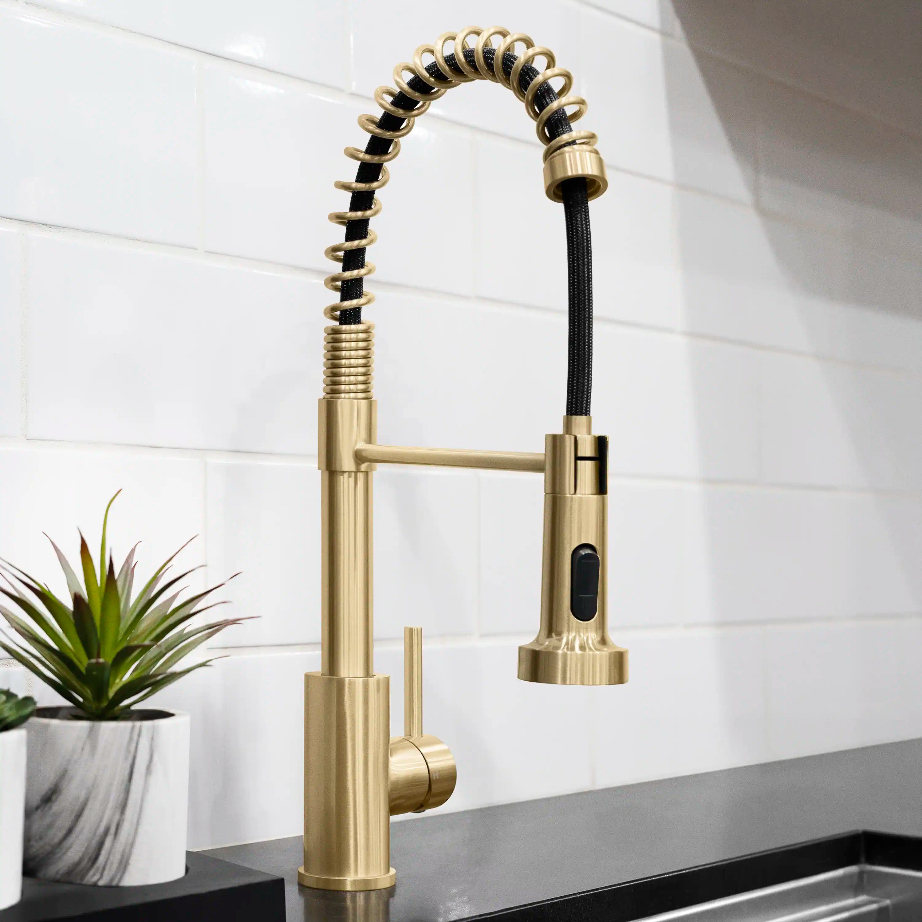 Champagne bronze kitchen faucet with tall curved spout and black pull-down hose