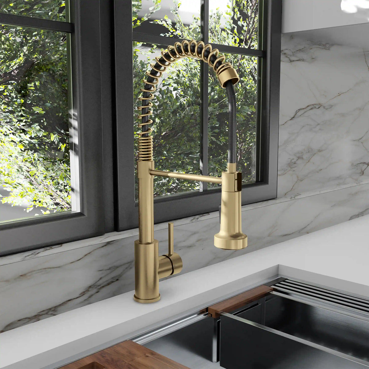 Champagne bronze pull-down faucet installed over sink with coiled spring hose