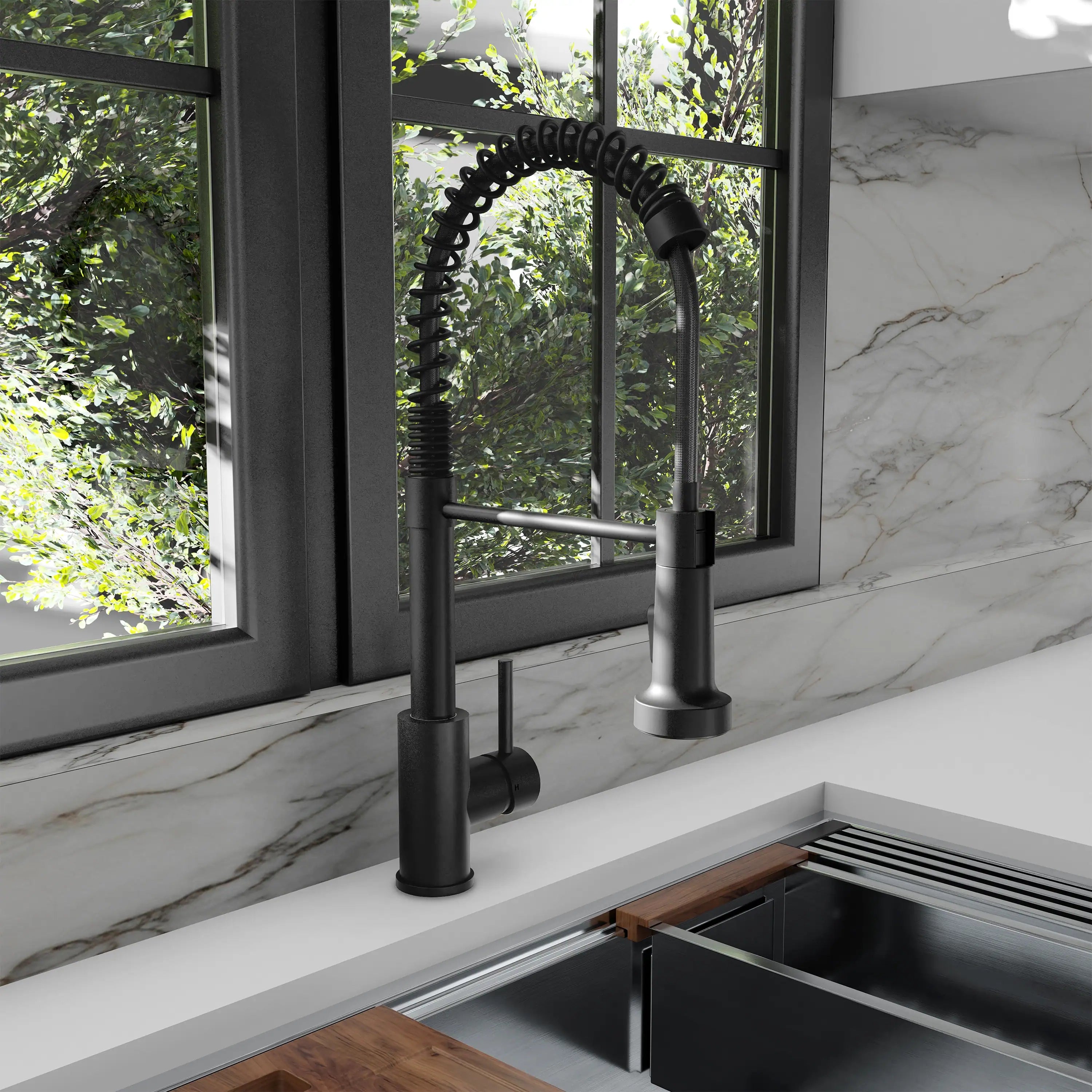 Matte black kitchen faucet with arched spout and pull-down sprayer over sink