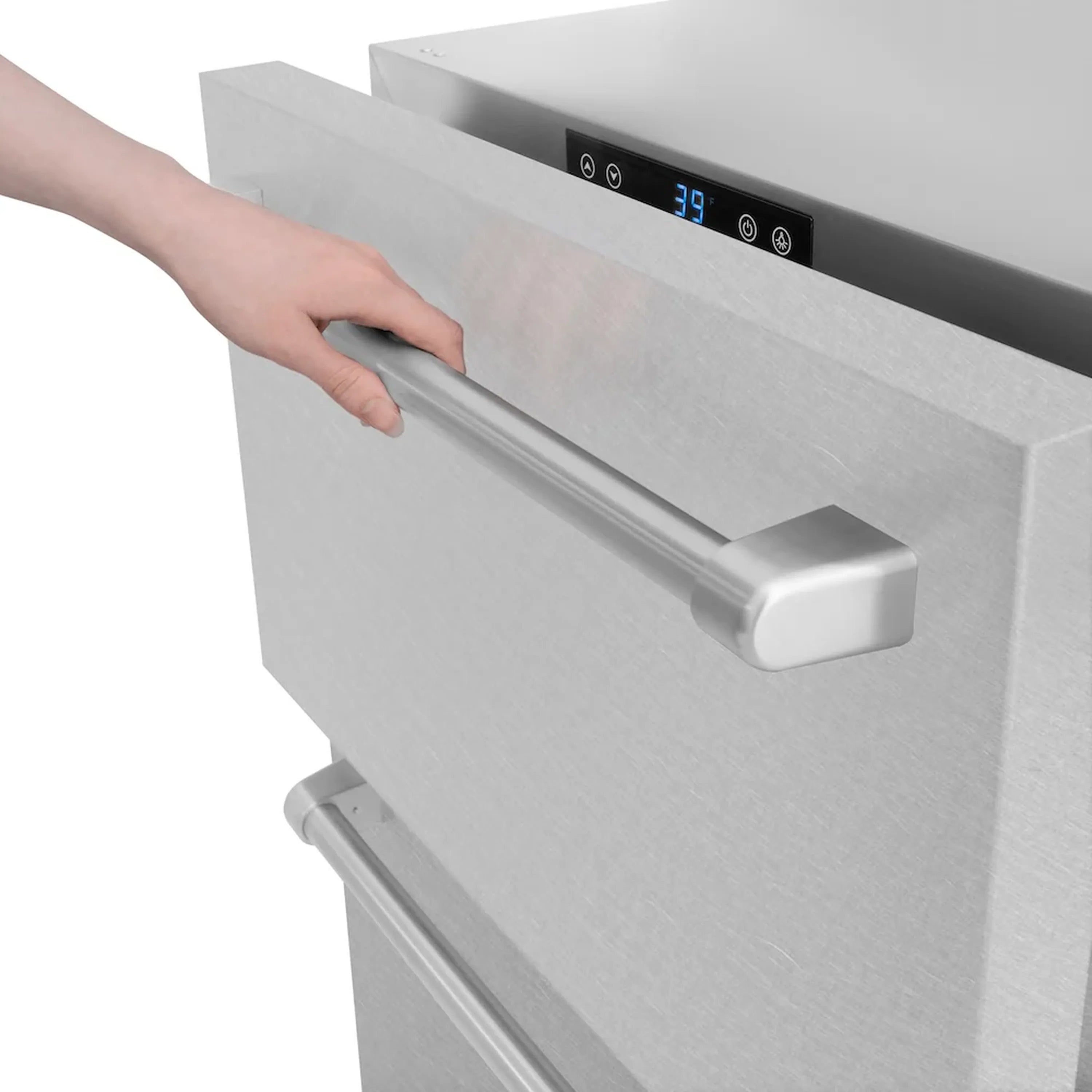 Hand pulling the front handle of a satin stainless steel refrigerator drawer