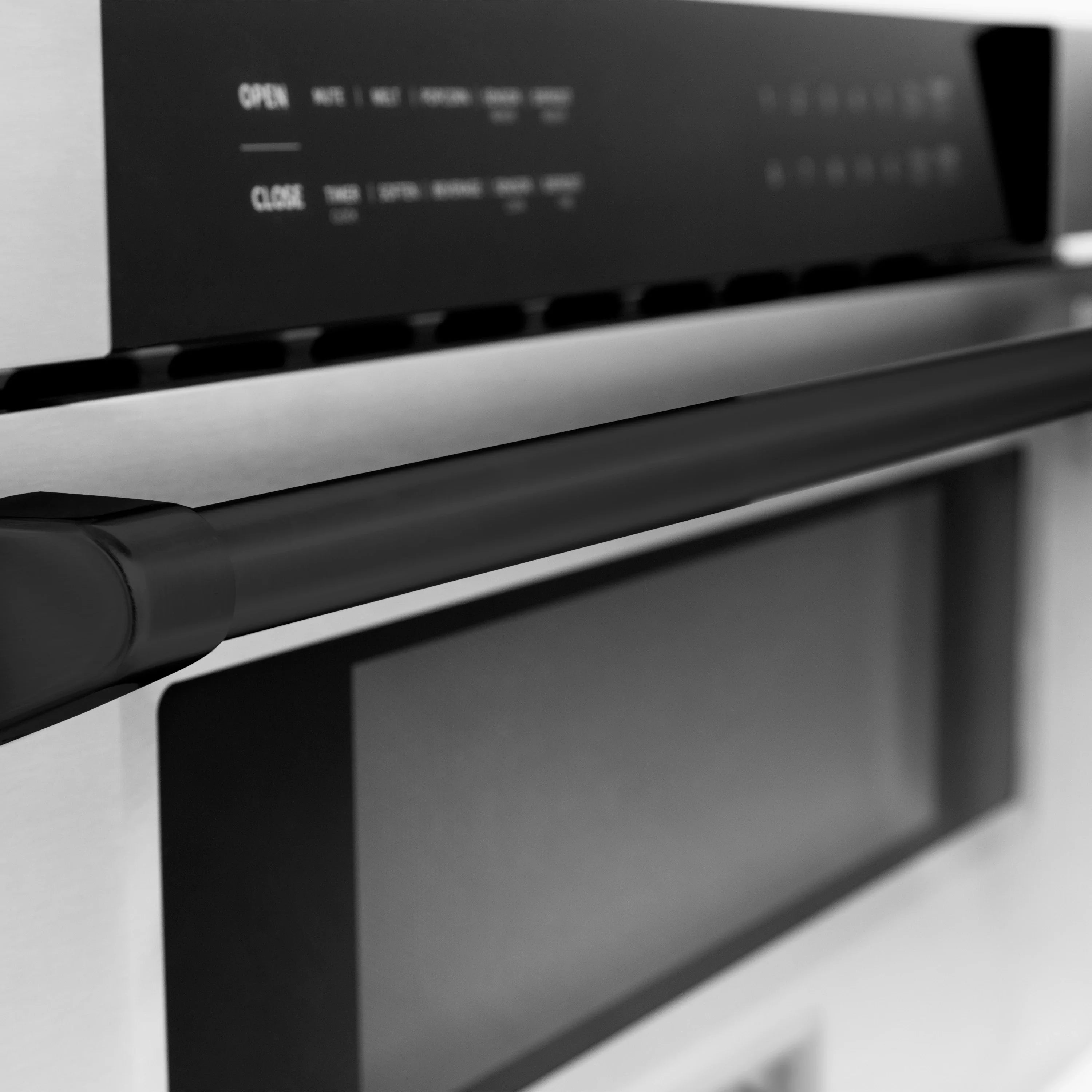 Stainless steel appliance front with black control display and dark cooktop panel