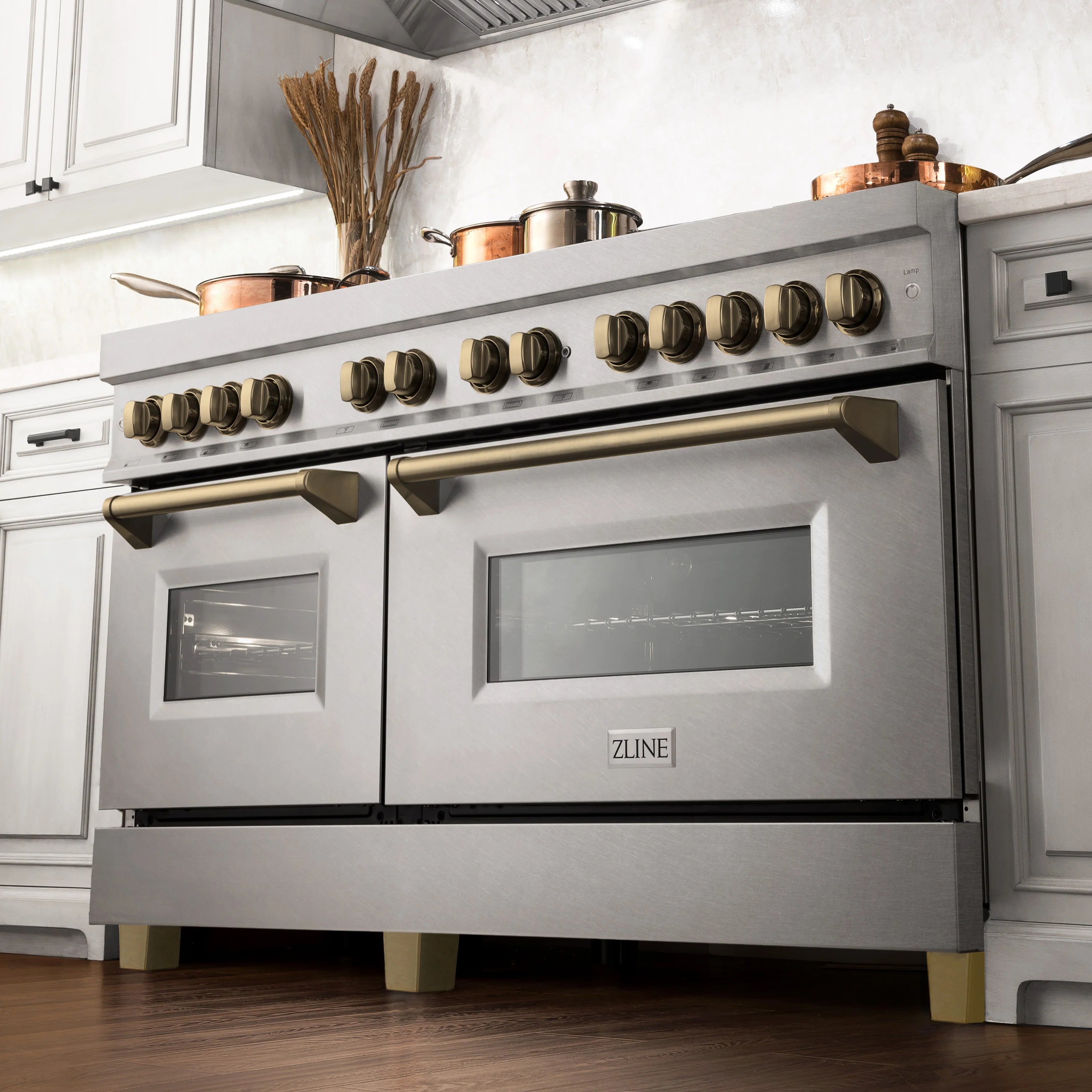 Dual fuel range with satin stainless front, champagne bronze knobs and long handle