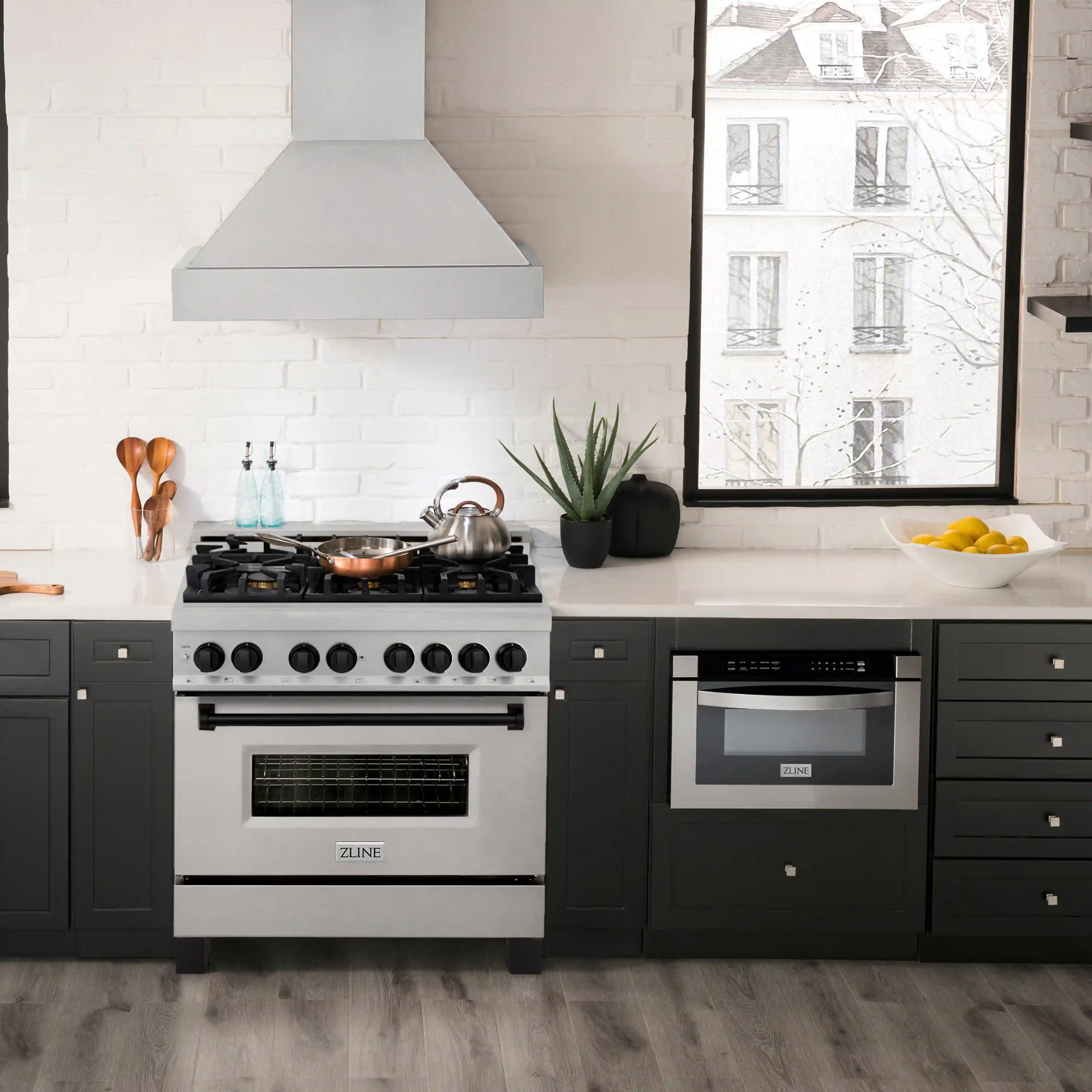Satin stainless dual-fuel range in kitchen with gas burners and black oven door