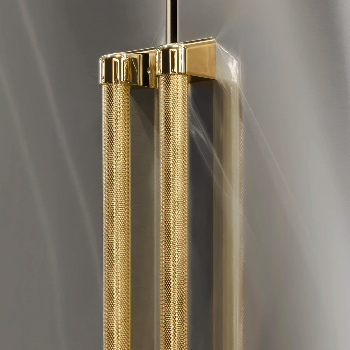 Gold helix handles with metallic hardware on stainless refrigerator door