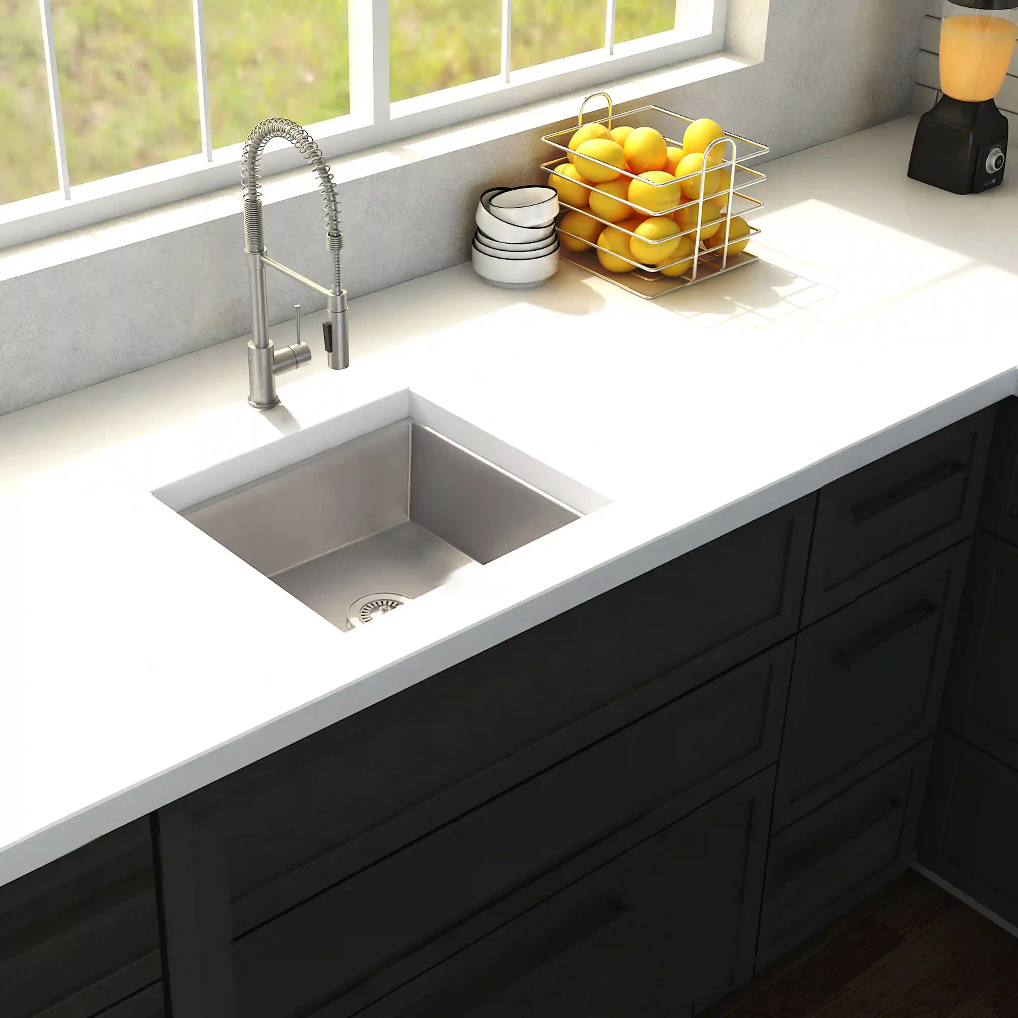 Stainless steel undermount single-bowl kitchen sink with faucet in a corner countertop.