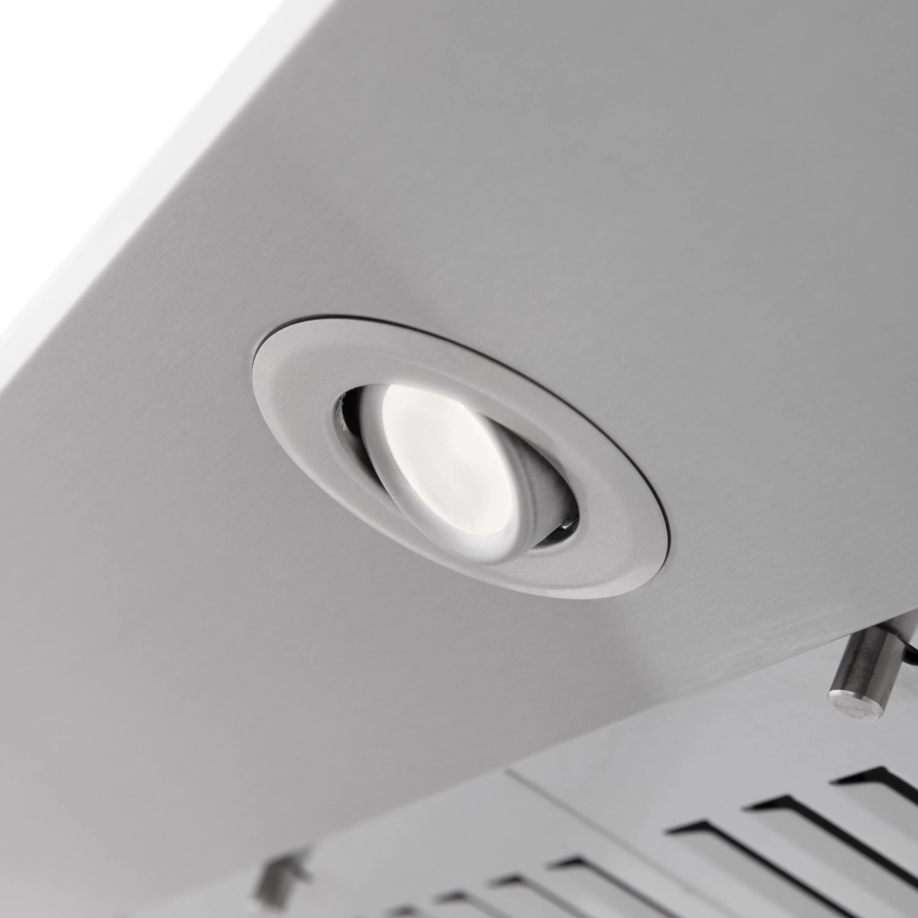Stainless range hood recessed light with round bezel on the underside