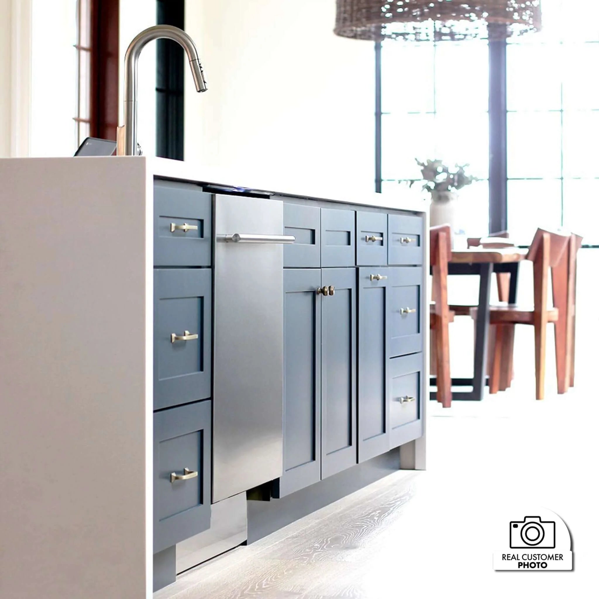 Built-in stainless steel dishwasher with modern handle installed in cabinetry