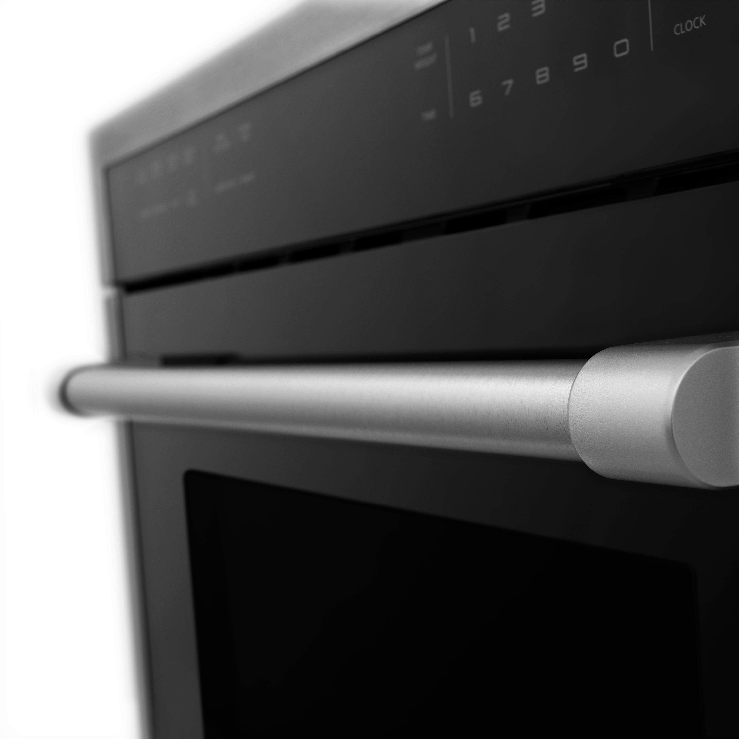 Black stainless range oven door handle and control panel close-up
