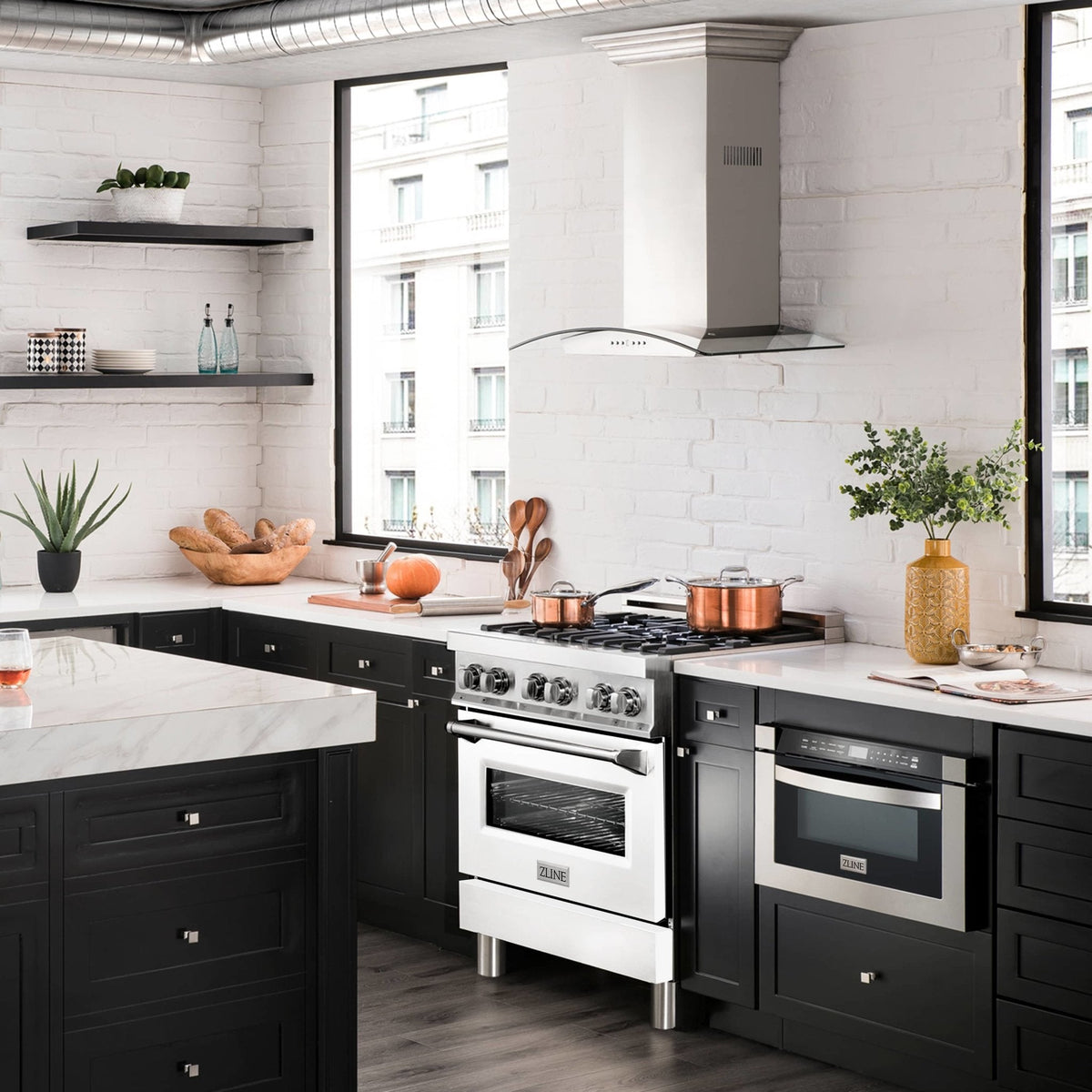 White dual fuel range with stainless hood in a modern kitchen with black cabinets