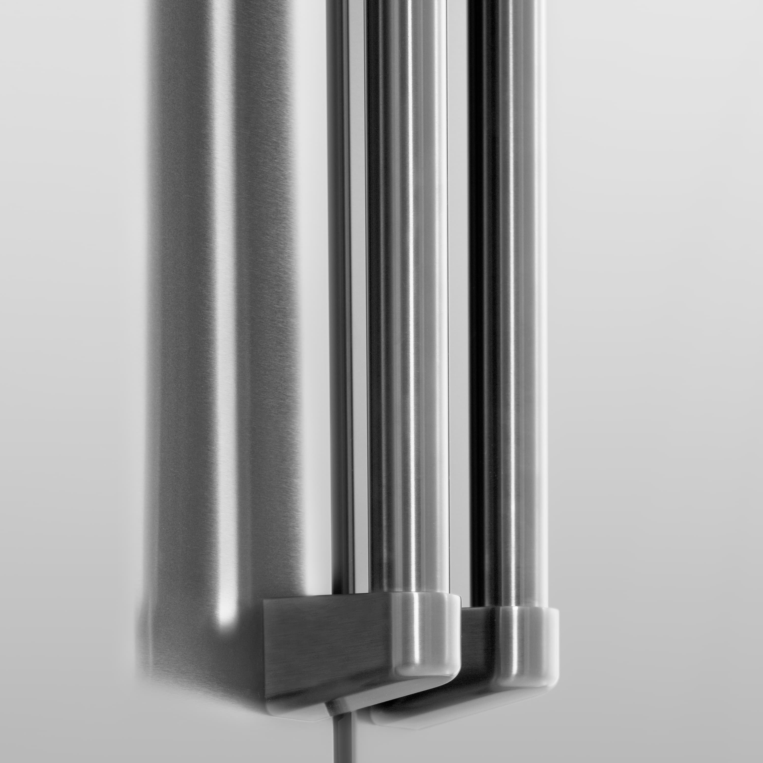 Stainless steel refrigerator dispenser area with vertical components and side mount