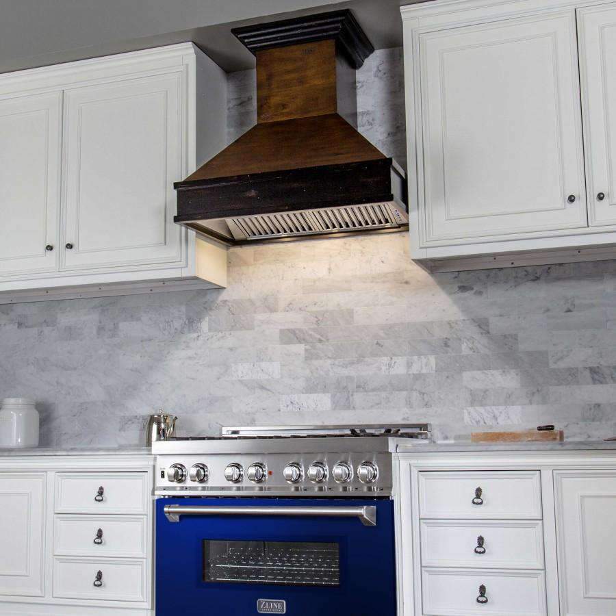 Dual fuel range with blue oven door and wall vent hood over the cooktop