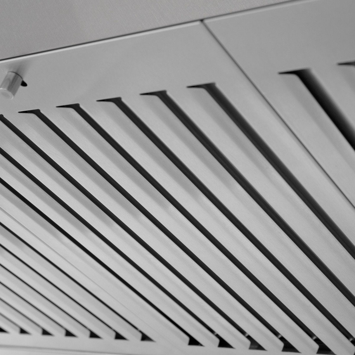 Close-up of stainless steel vent grille with evenly spaced slats