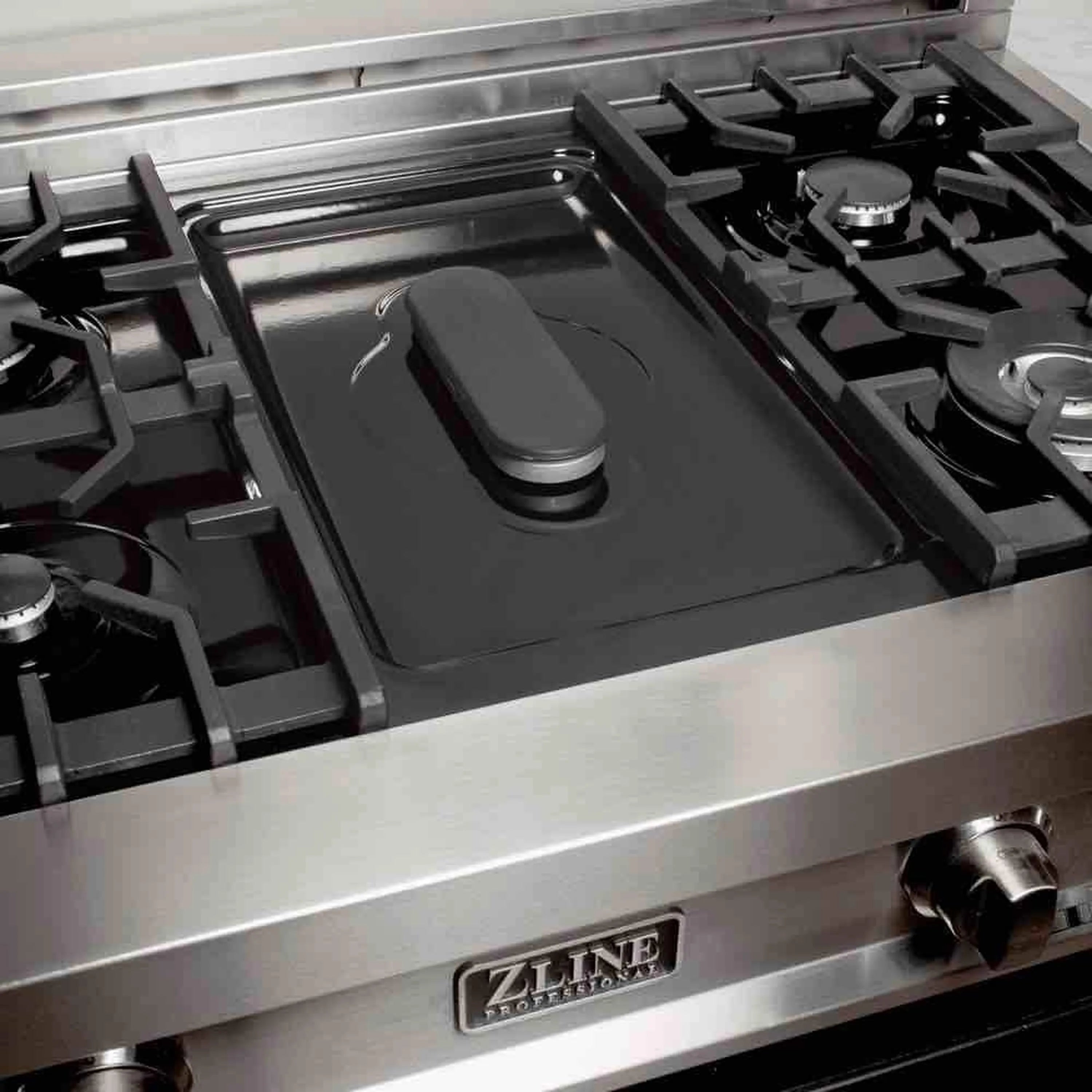 Stainless griddle insert with control knob on dual fuel cooktop