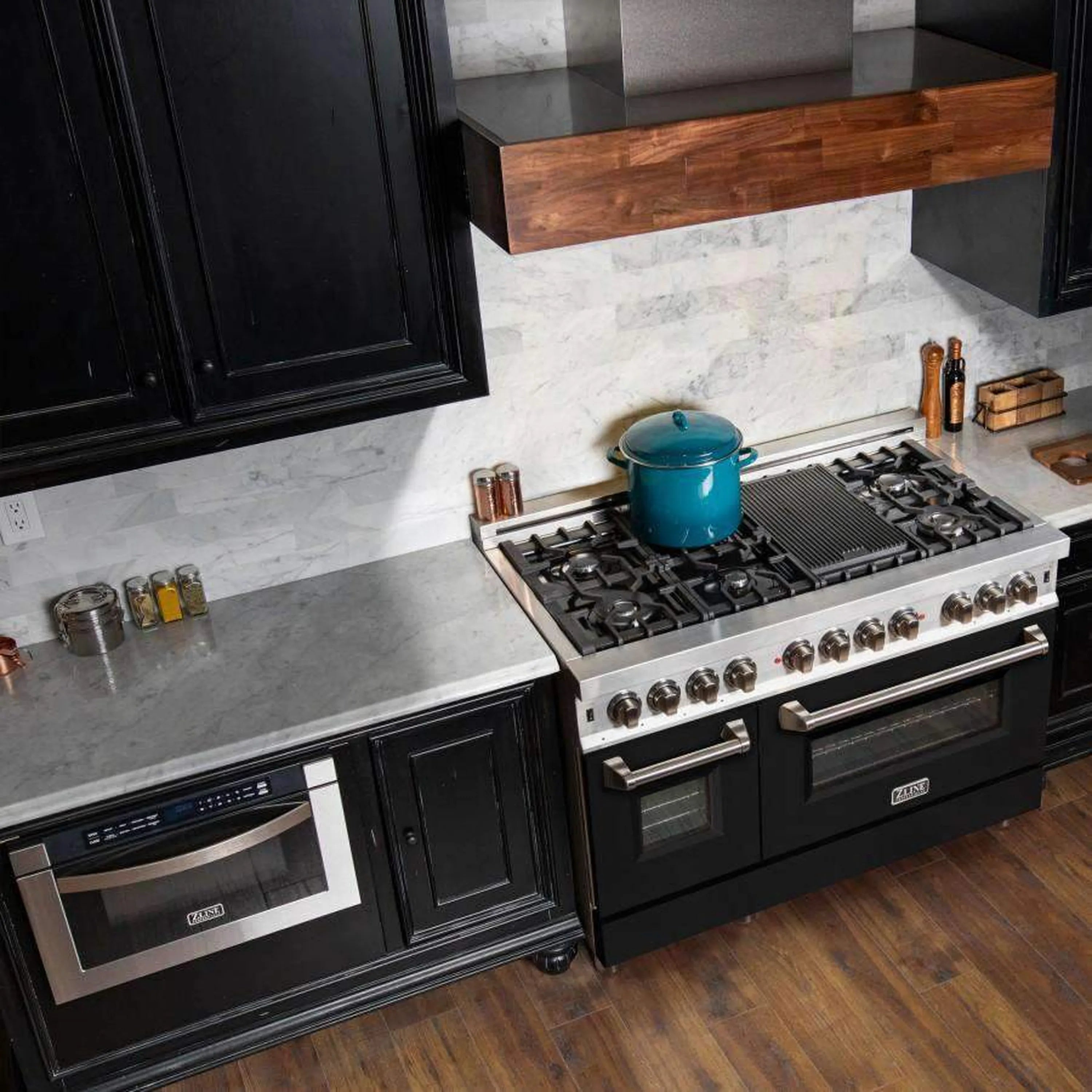 Stainless dual fuel range with black doors in modern kitchen setting