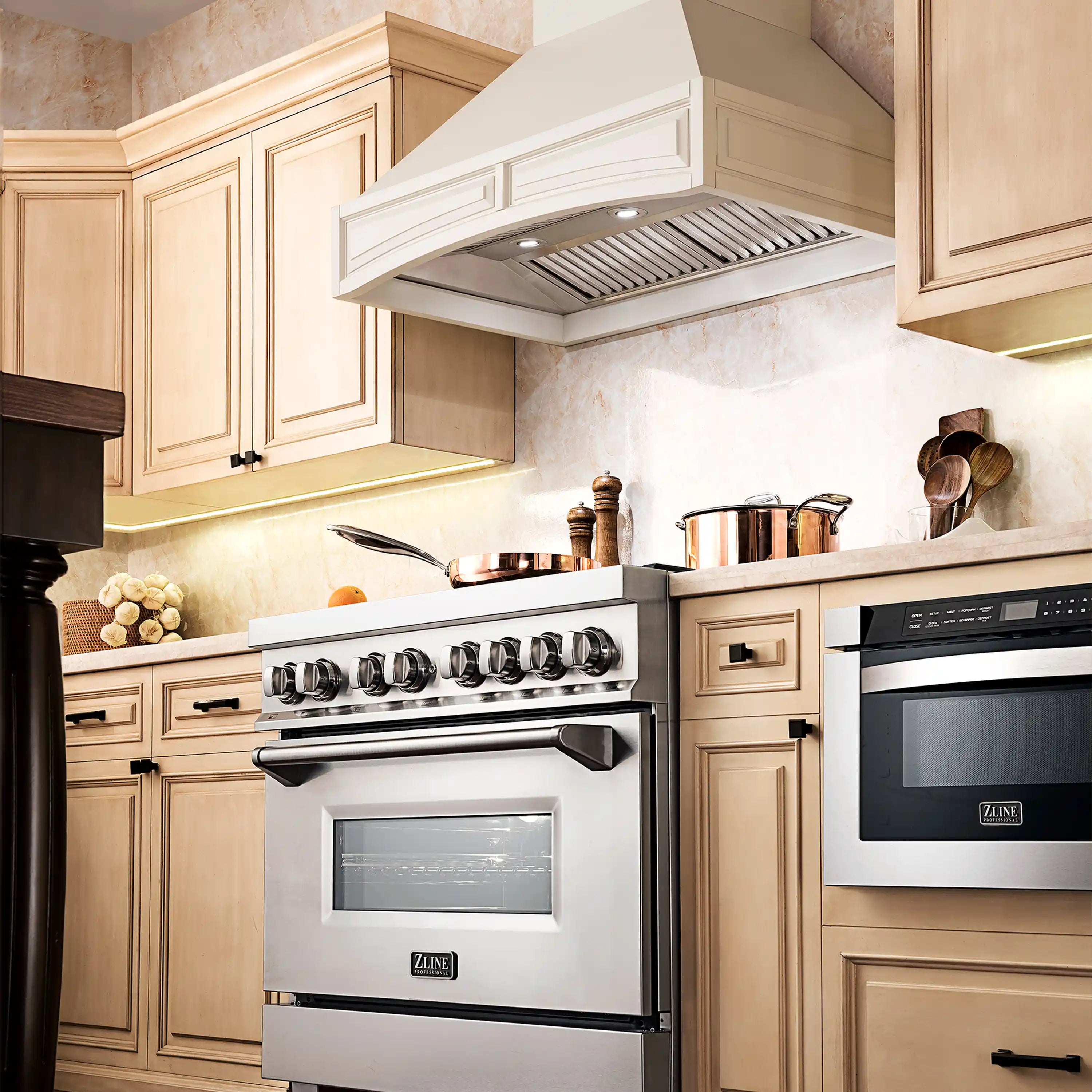 White wall-mount range hood above stove with vent grille and controls