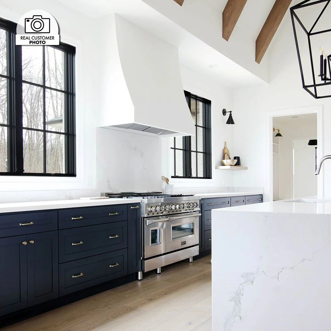 Stainless steel range hood insert above cooktop with vent grilles
