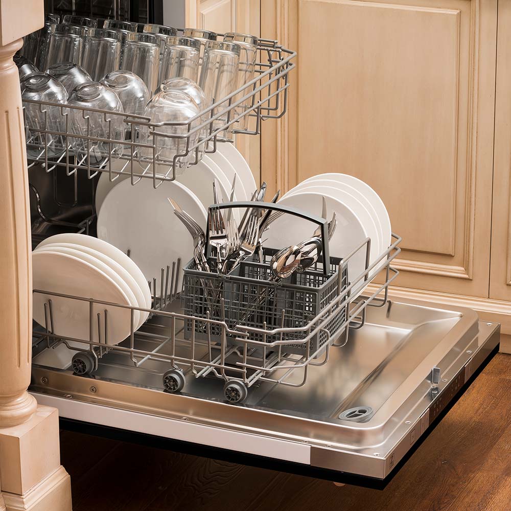 Open dishwasher in kitchen with loaded racks and stainless tub base