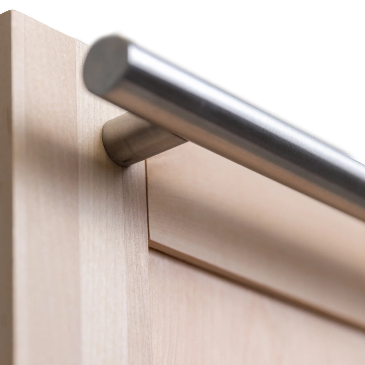 Close-up of stainless handle attachment on unfinished wood dishwasher door