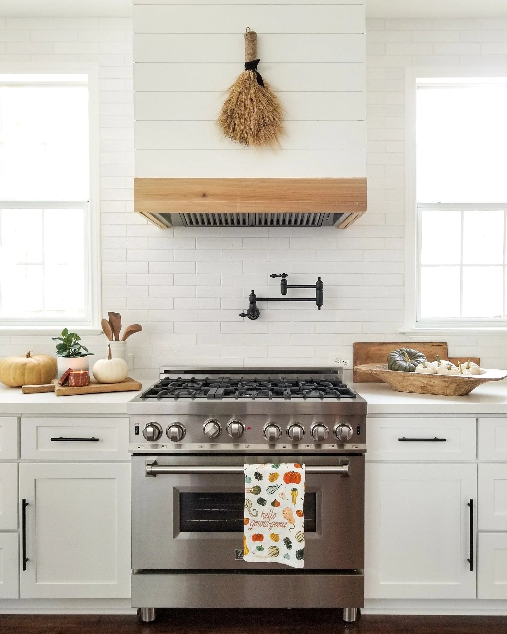 Stainless steel under-cabinet range hood insert with vented canopy above stove