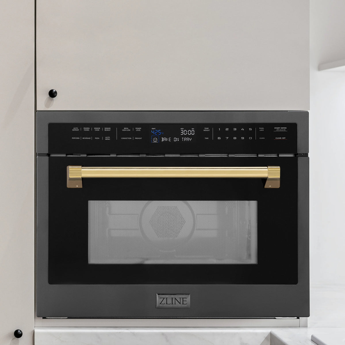 Black stainless built-in convection microwave with gold handle accents and clear glass door