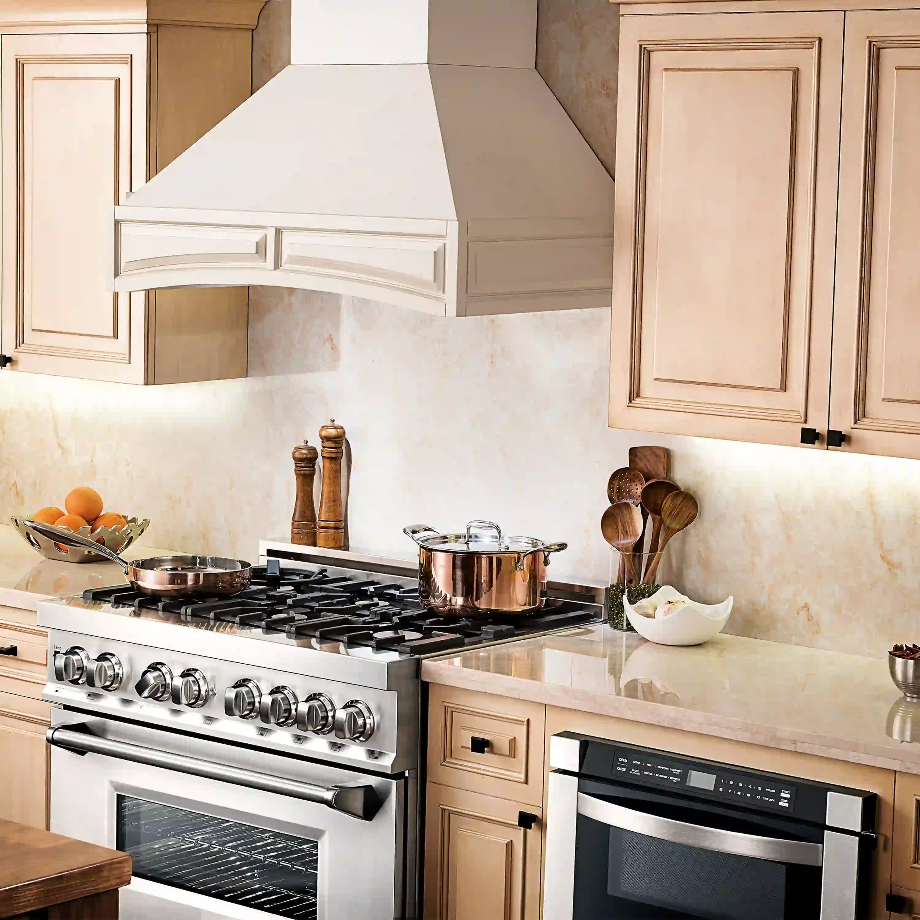 White wall range hood close-up with vent grille, chimney body and stove