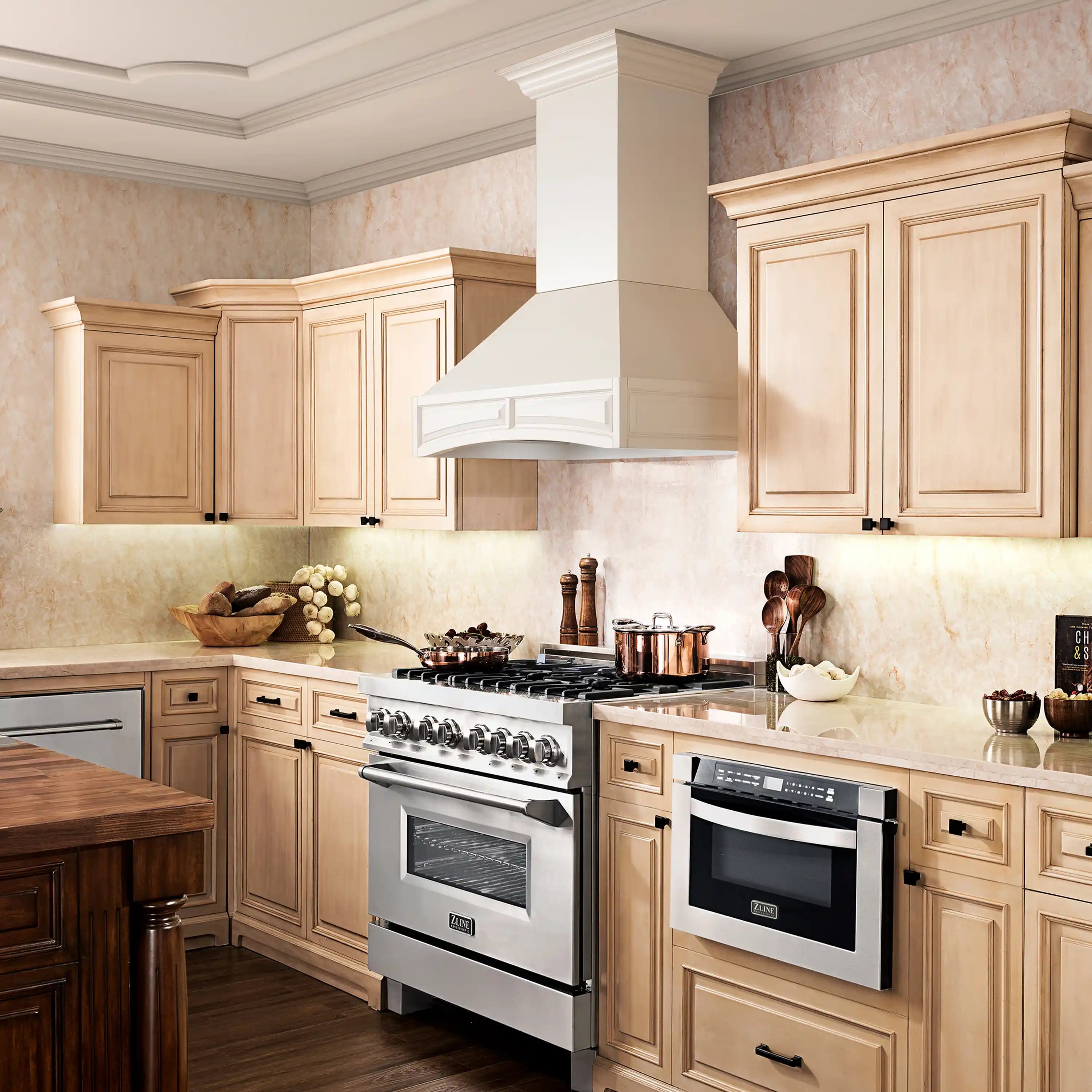 White chimney wall range hood centered over stove in light wood cabinetry